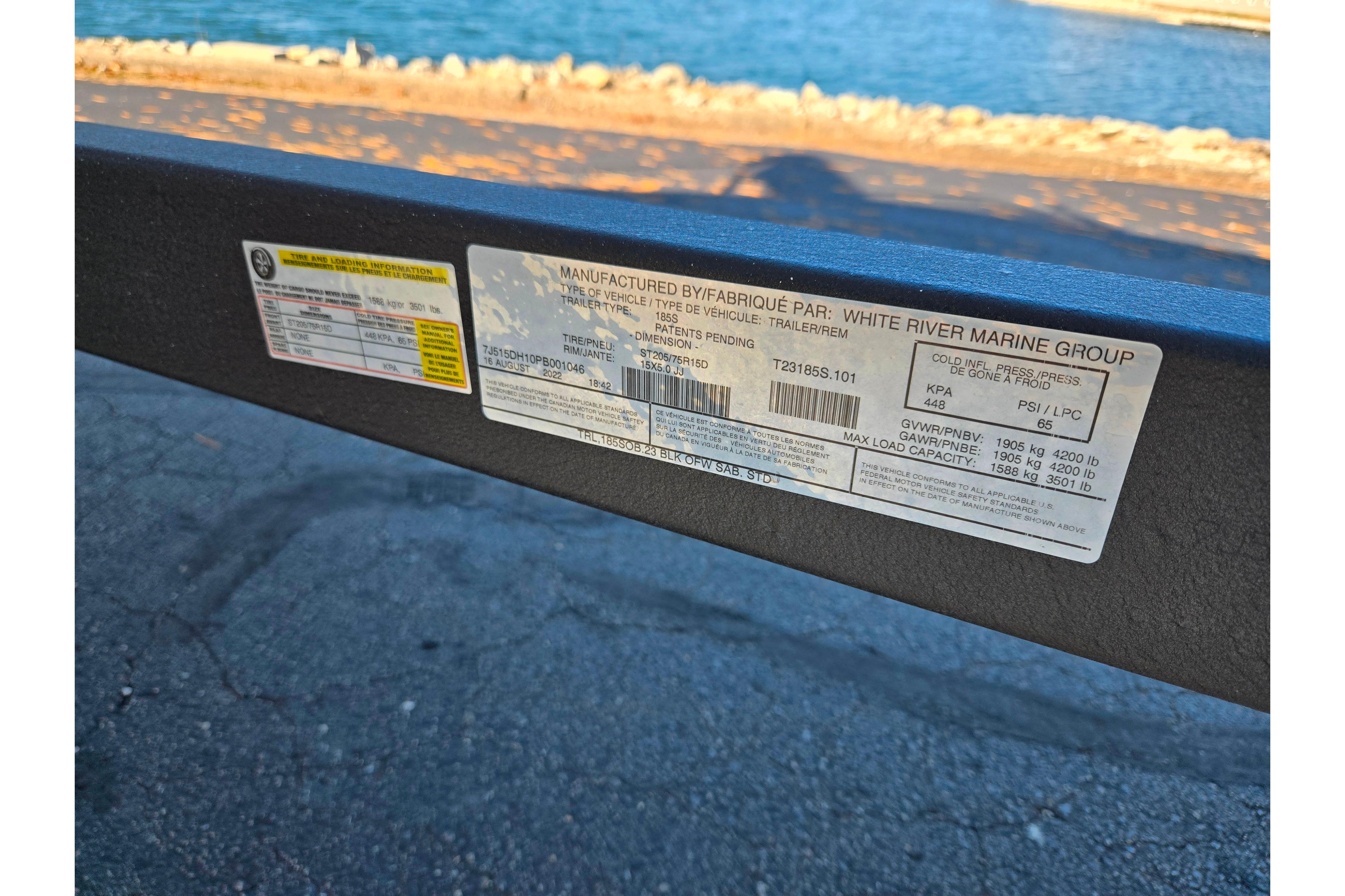 Label on 2023 Tahoe 185 S trailer by White River Marine Group near water.