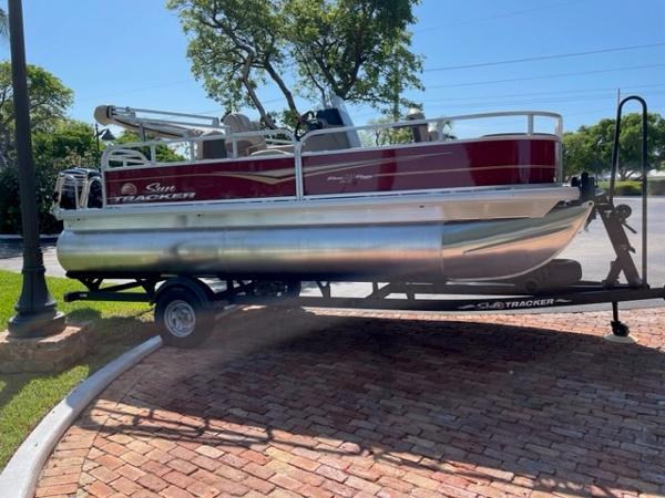2024 Sun Tracker Bass Buggy 18 DLX pontoon boat on a trailer.