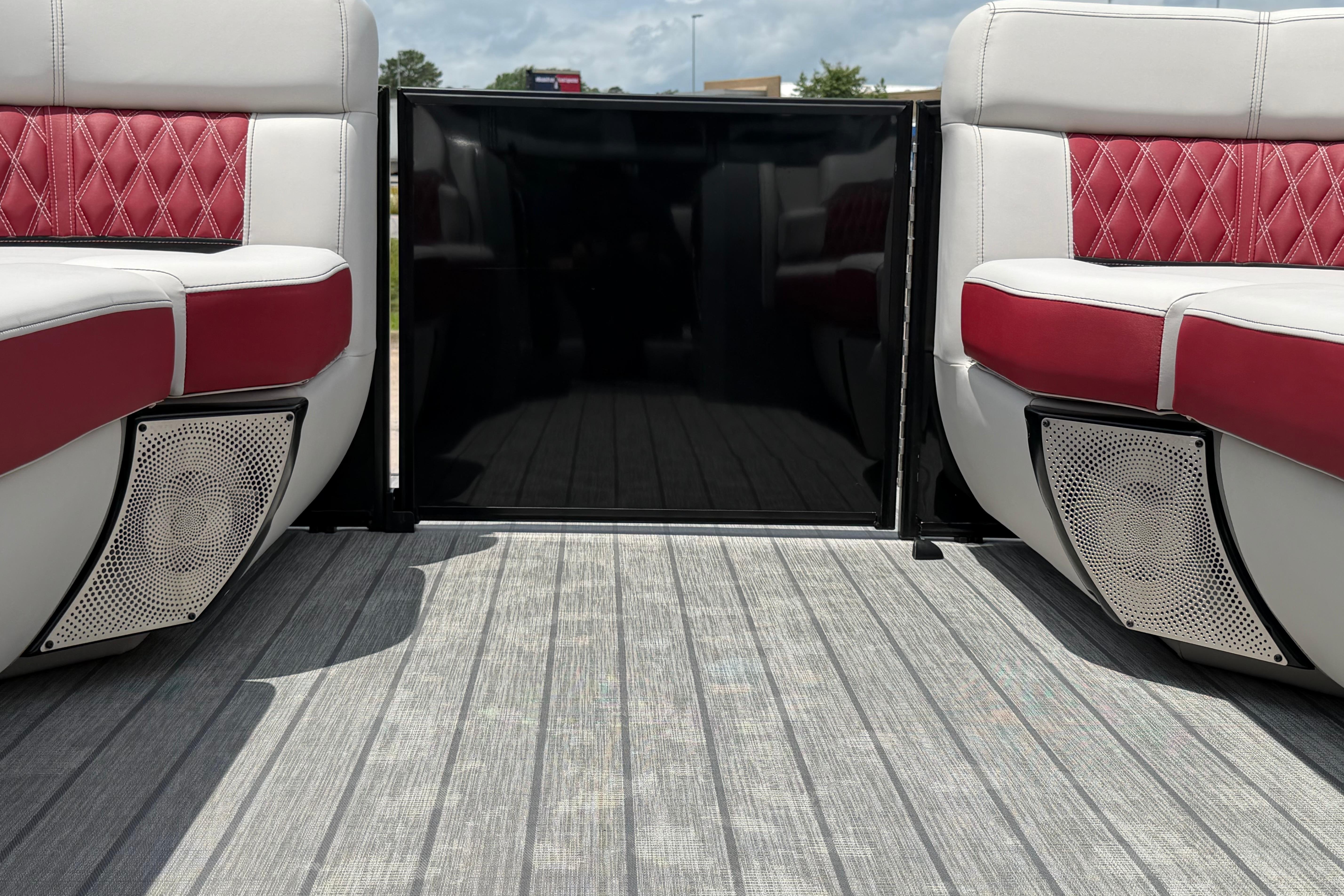Luxury seating on 2023 Godfrey Sanpan 2700 ULW Twin pontoon boat with stylish red accents.