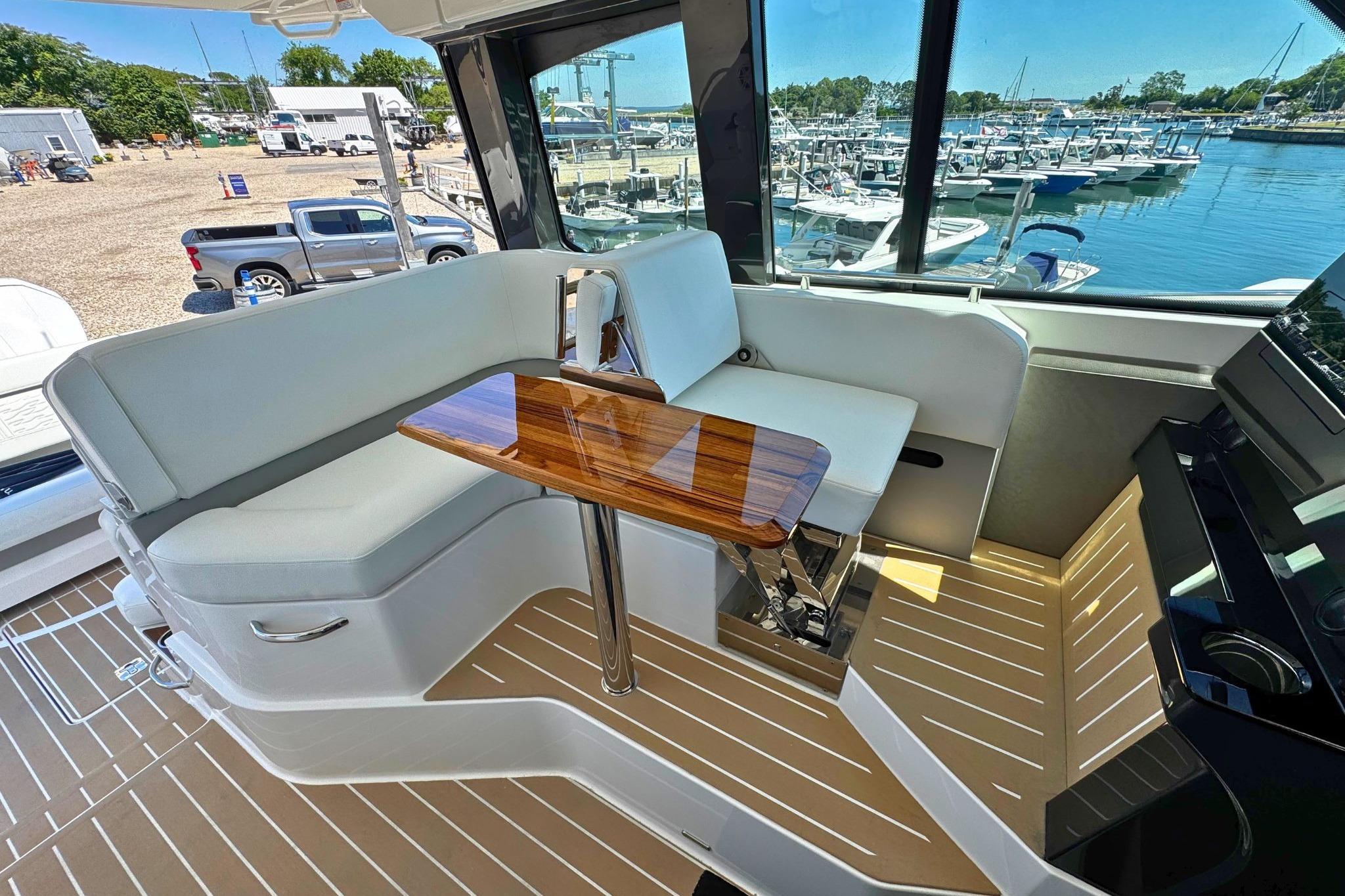 Luxurious interior of 2027 Tiara Yachts 39 LE with elegant seating and wooden table.