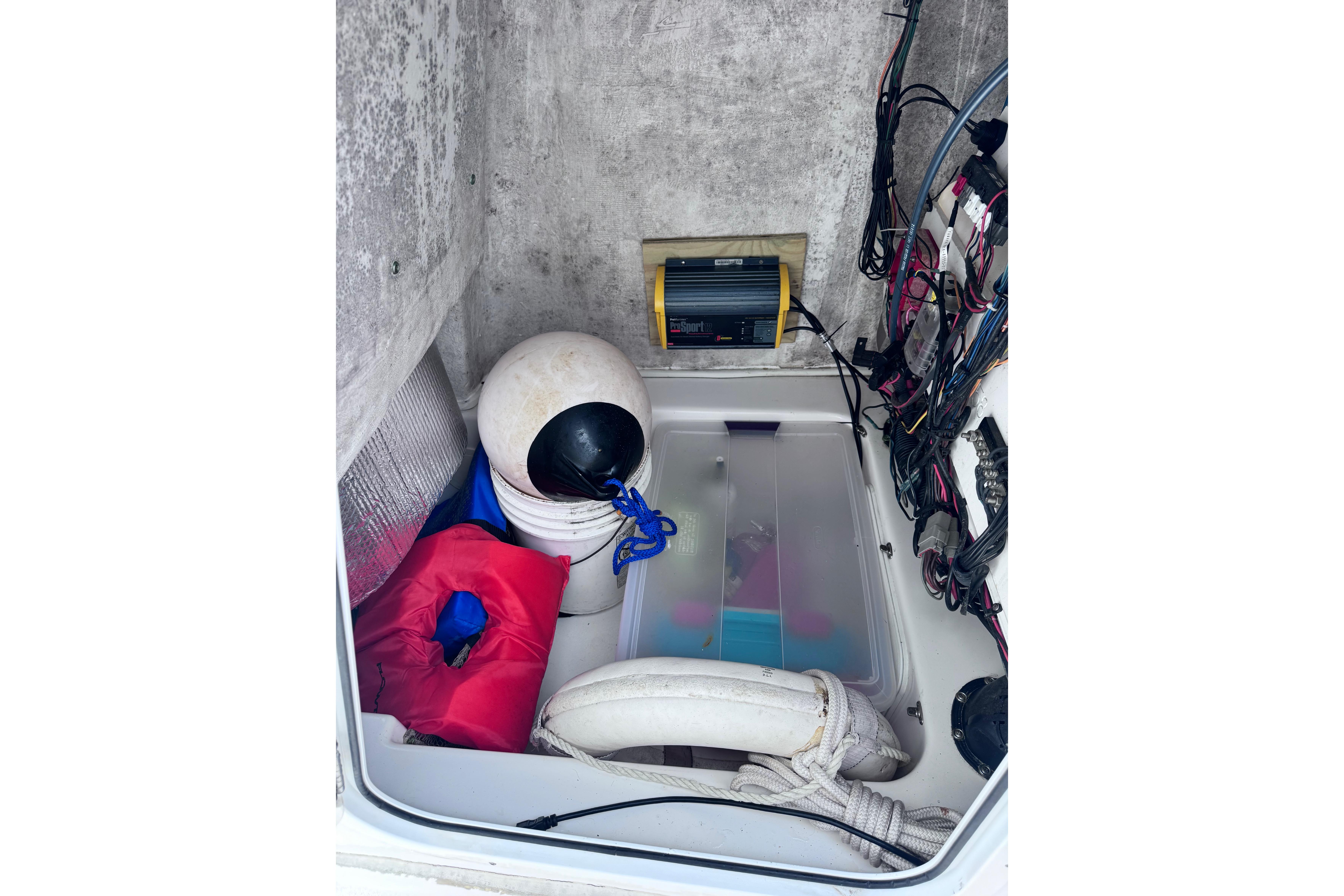 Storage compartment of a 2018 Sea Fox 206 Commander boat with safety equipment.