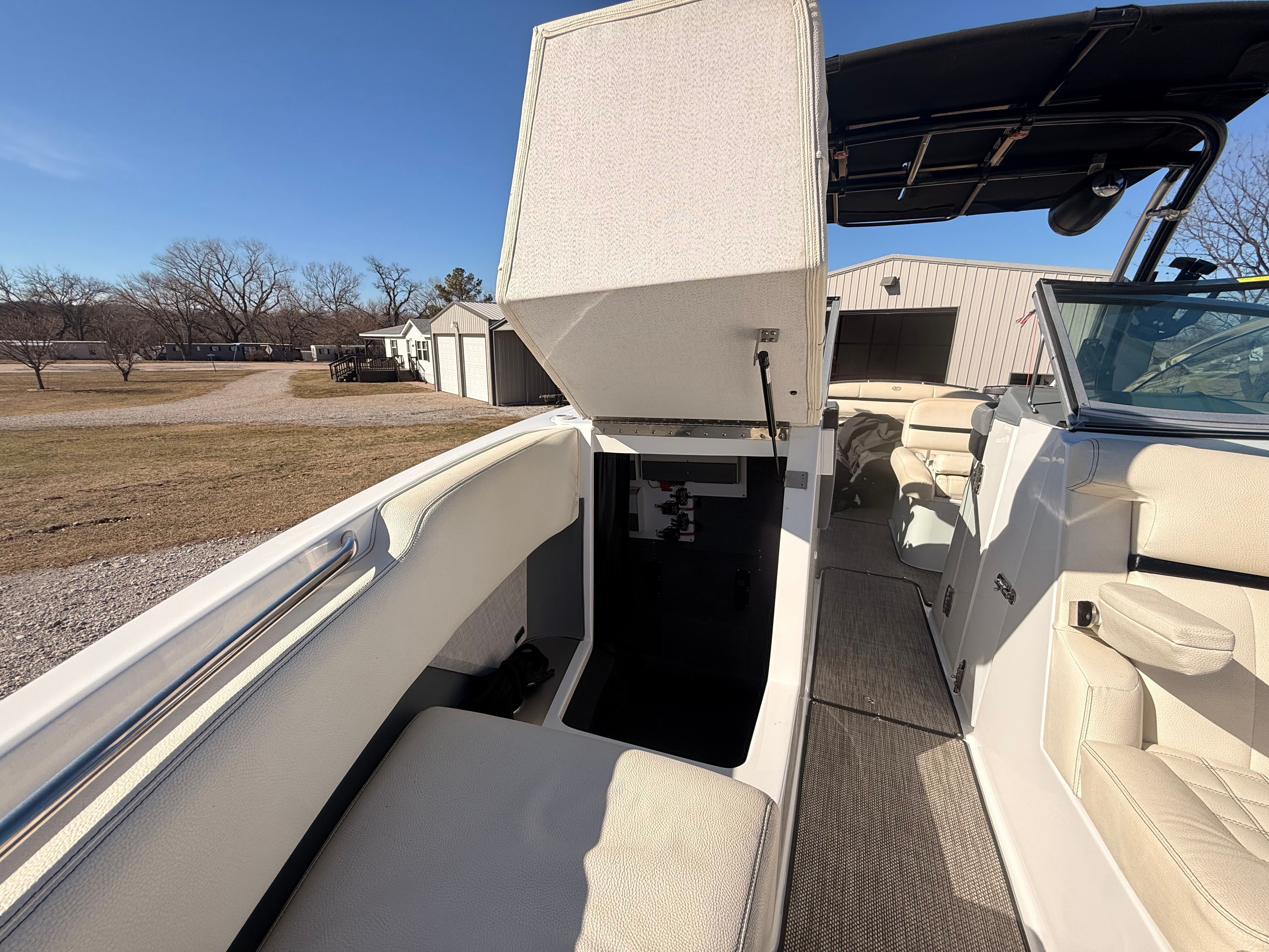 The image shows the cockpit of a 2019 Cobalt R7 Surf boat with an open storage compartment.