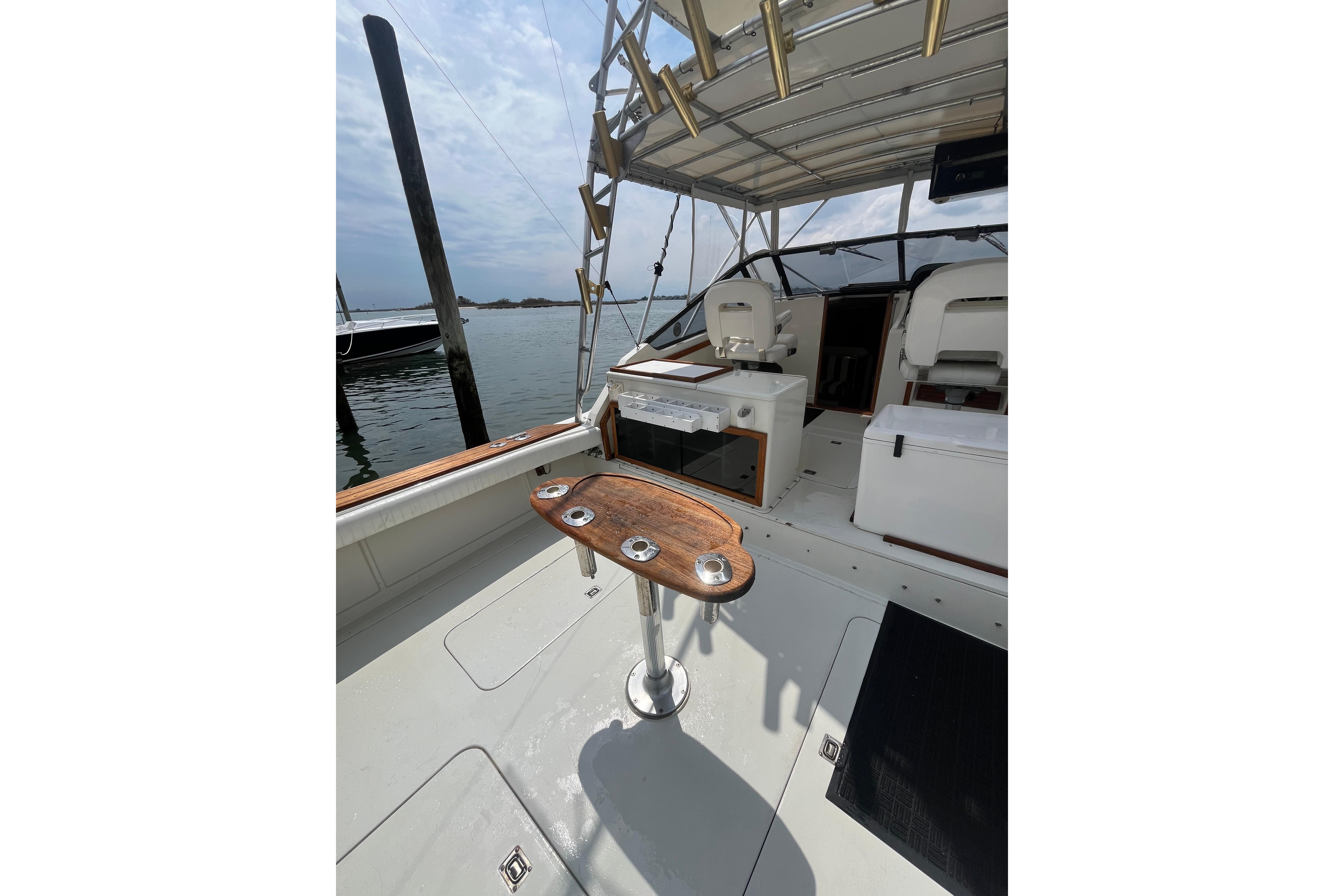 1989 Blackfin 31 Combi boat interior with fishing rod holders and seating.