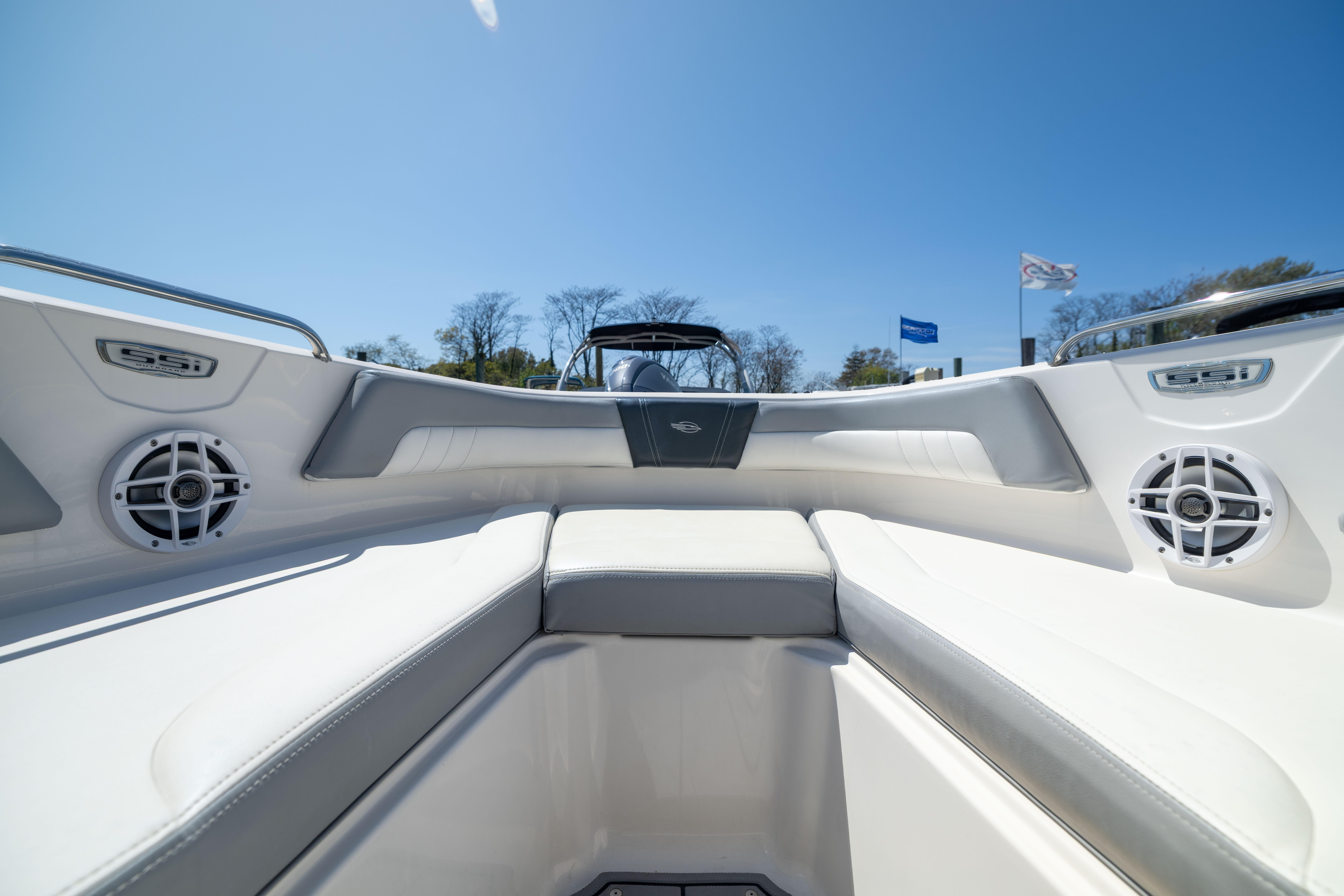 2022 Chaparral 21 SSi OB boat interior with white seating and speakers.