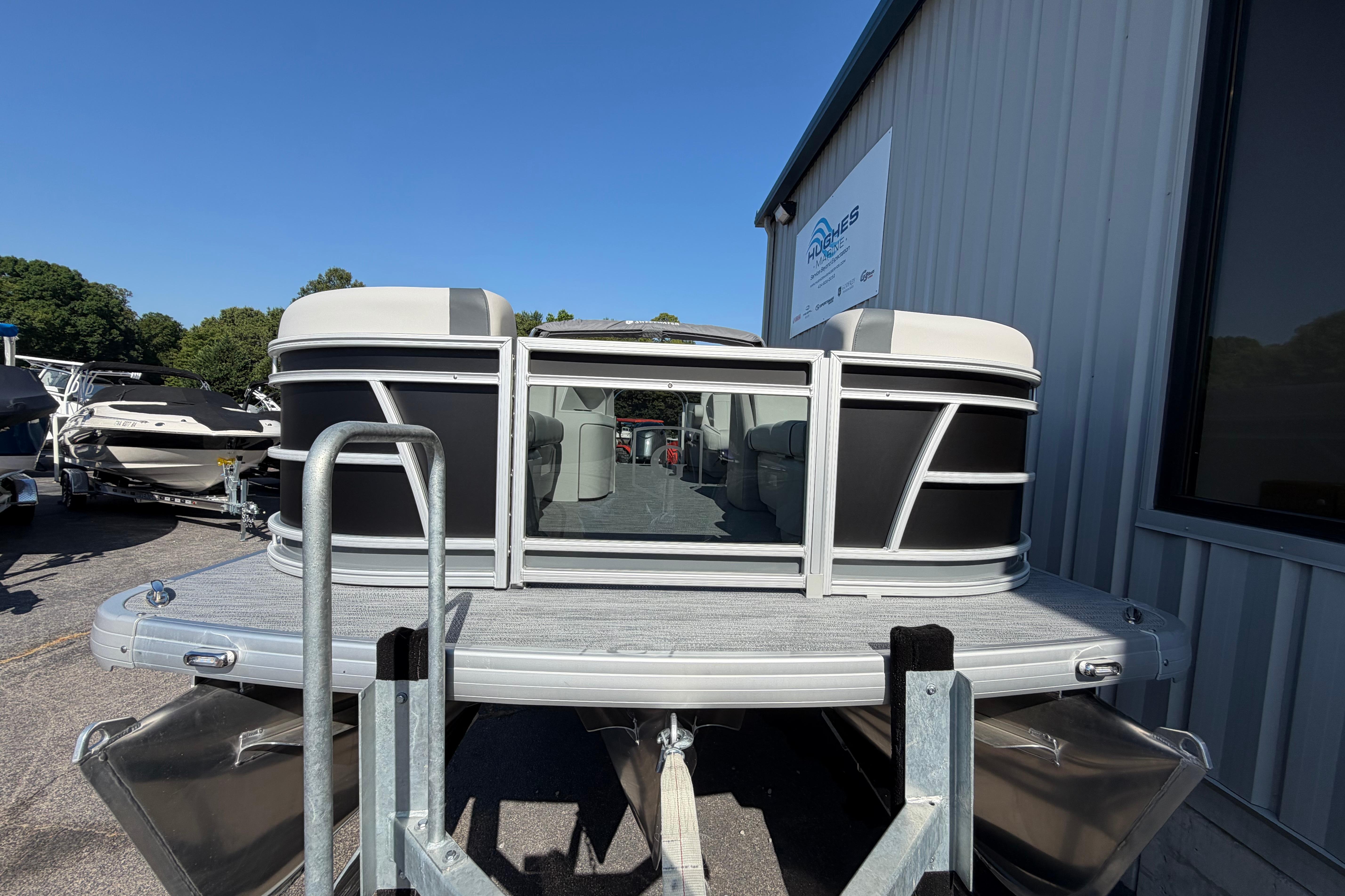 2026 Godfrey Sweetwater 2086 SBC pontoon boat displayed outdoors near a building.