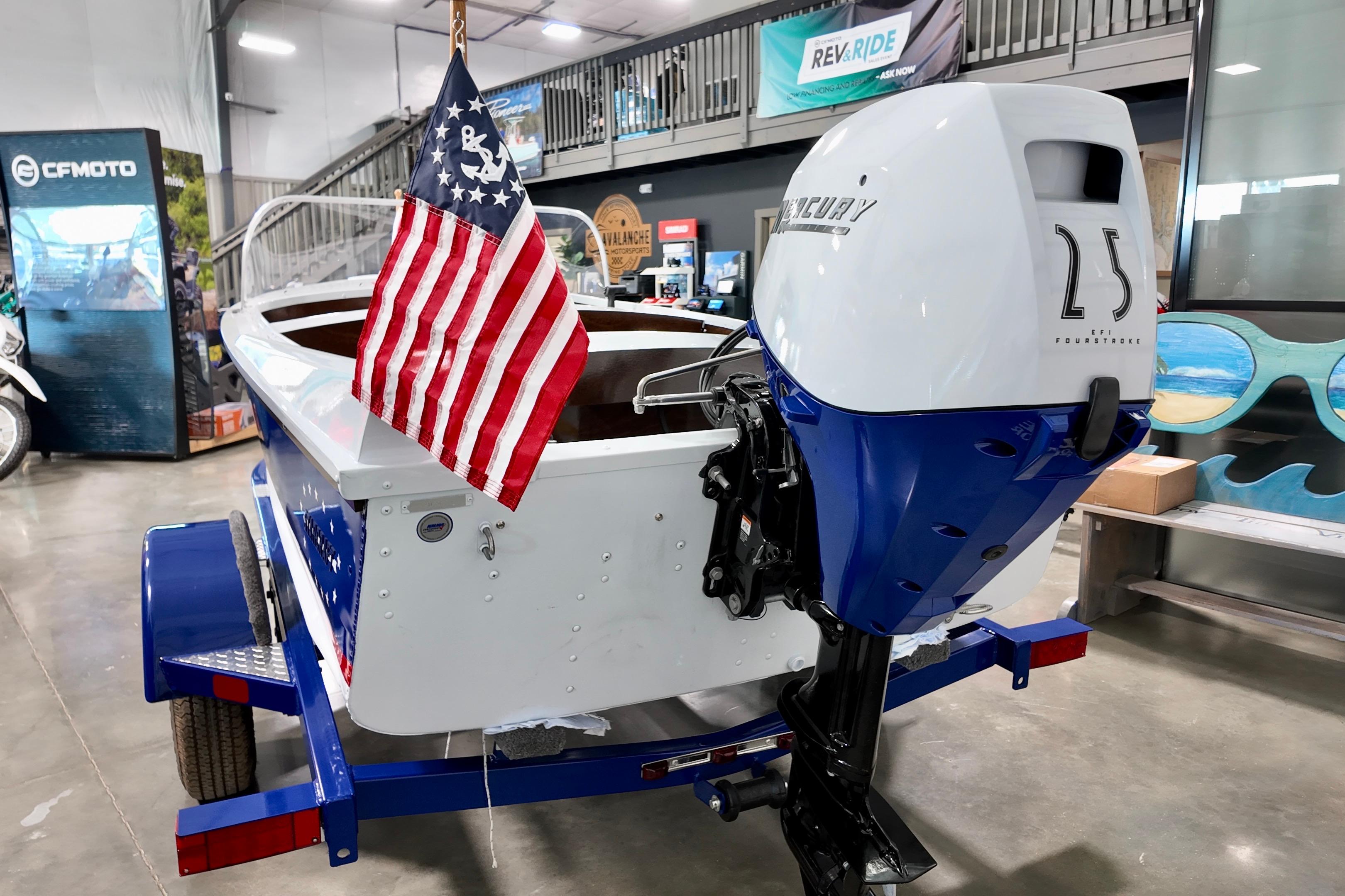 2026 Starcraft 57 Ski Champ boat with Mercury 25 engine and American flag display.
