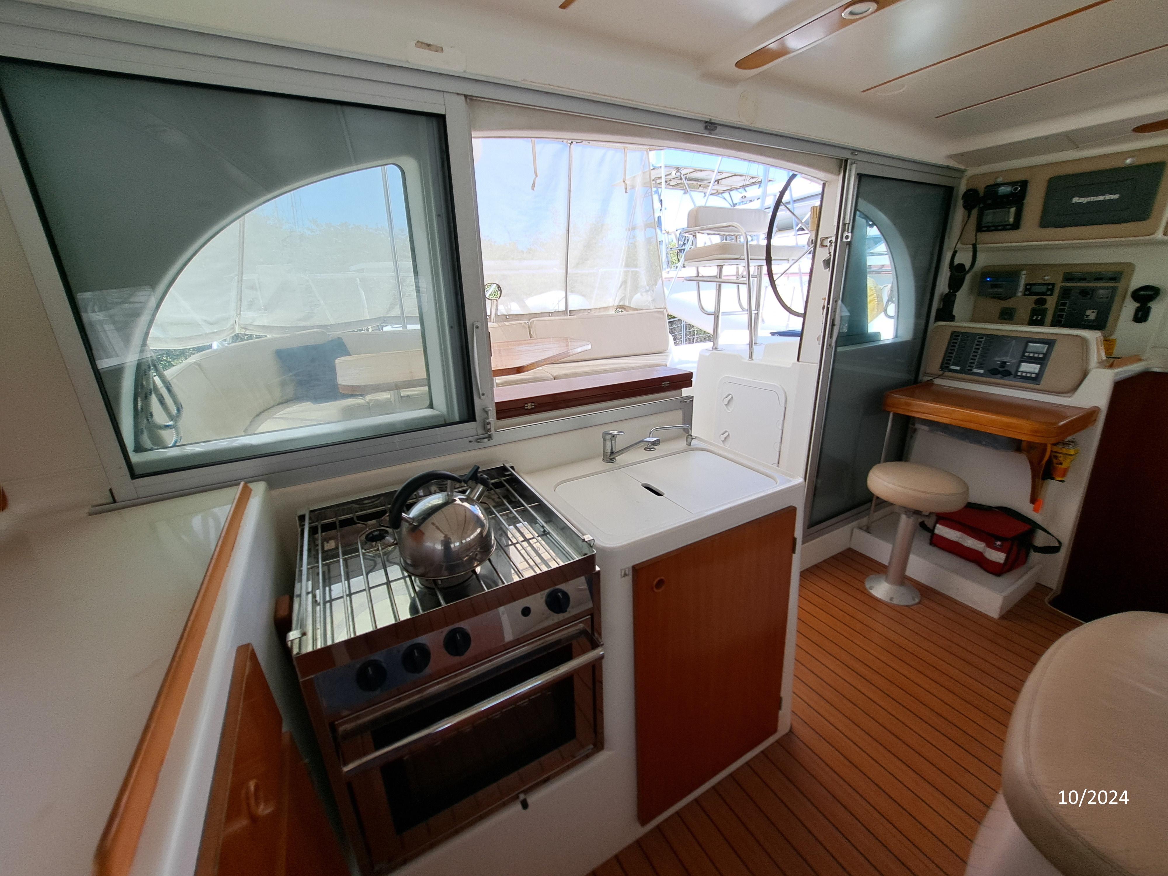 Interior of 2001 Lagoon 380 catamaran with kitchen and navigation area.