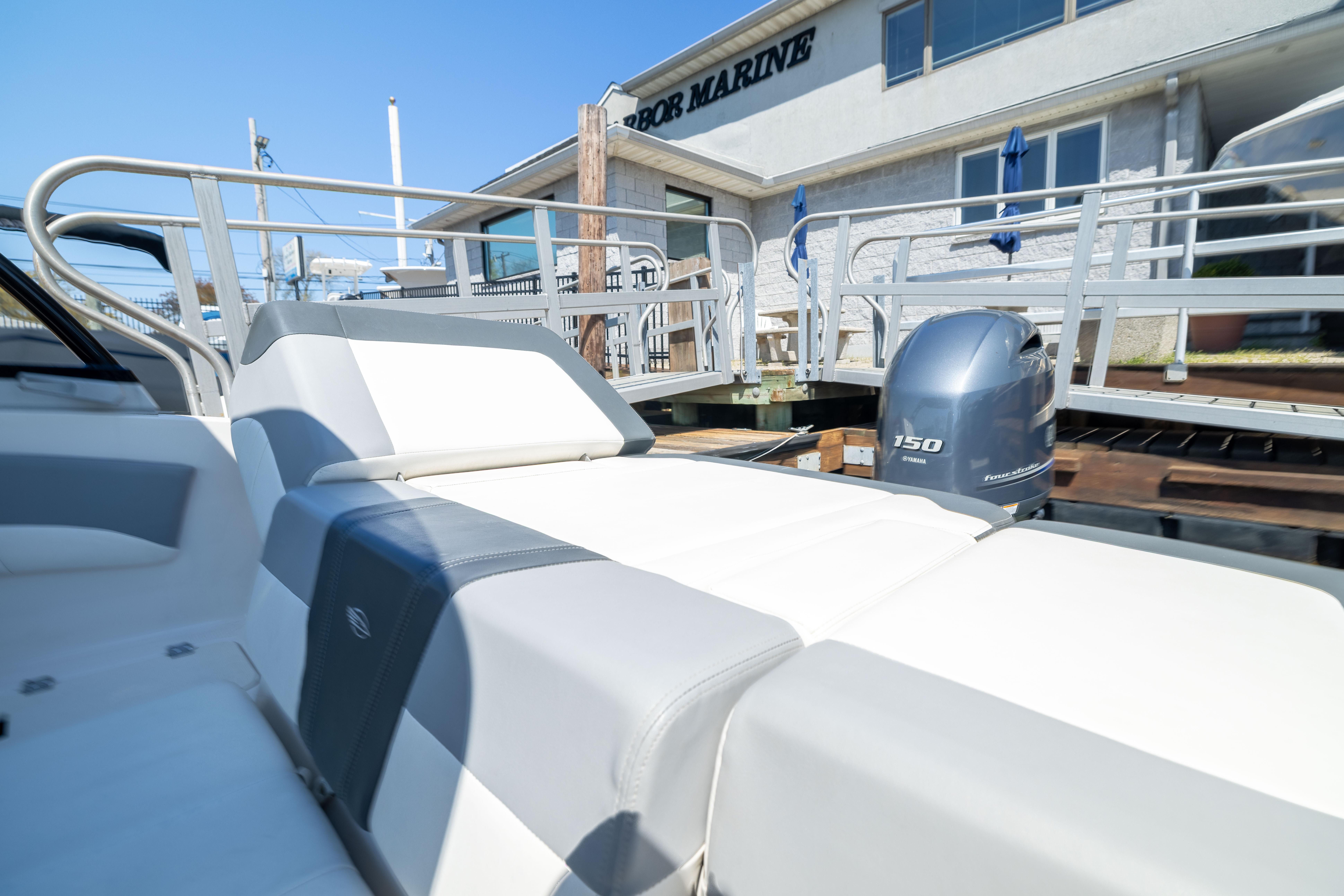 2022 Chaparral 21 SSi OB boat with Yamaha 150 engine at dockside.
