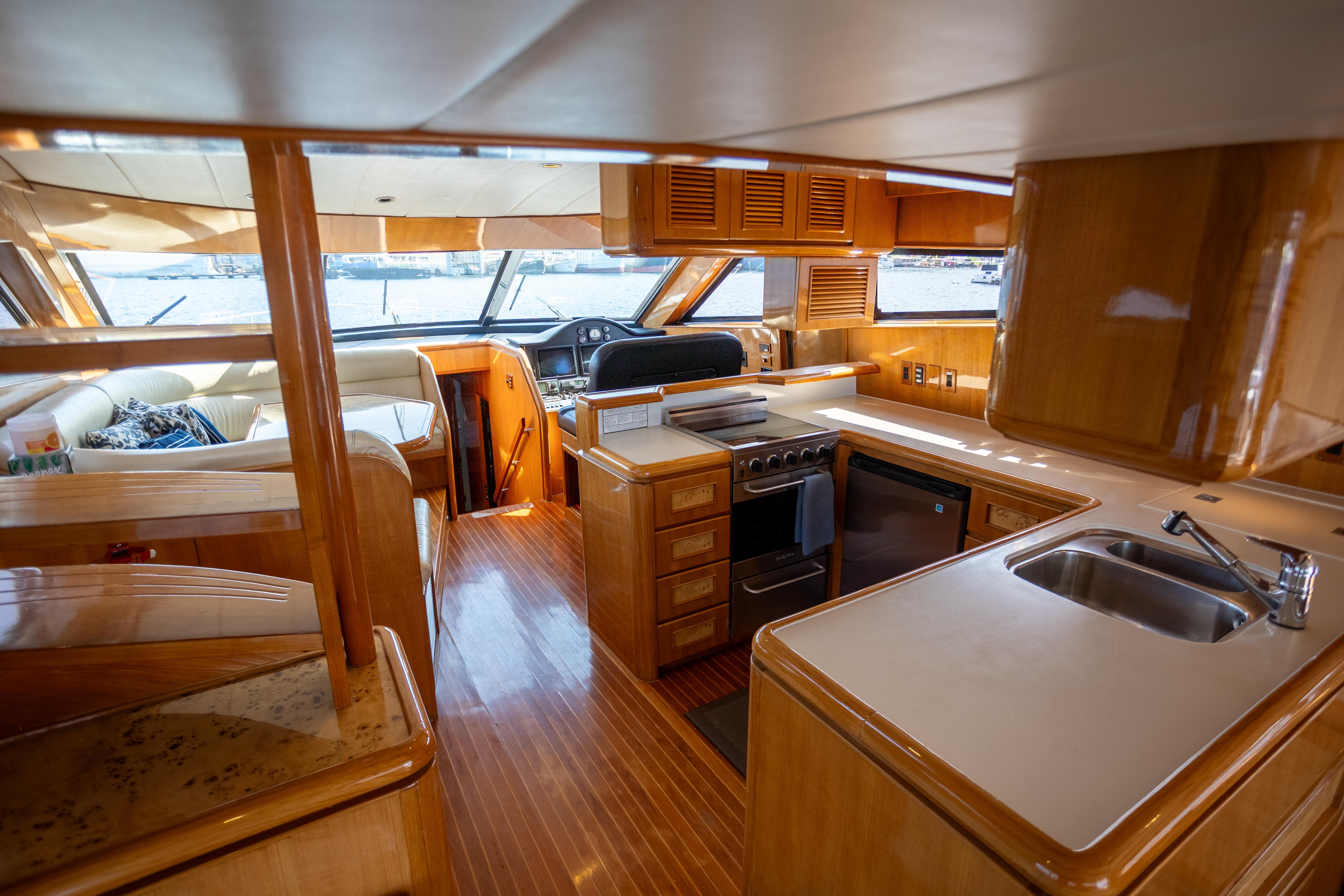Luxurious interior of a 2001 Vitech 72 yacht with modern kitchen and seating area.
