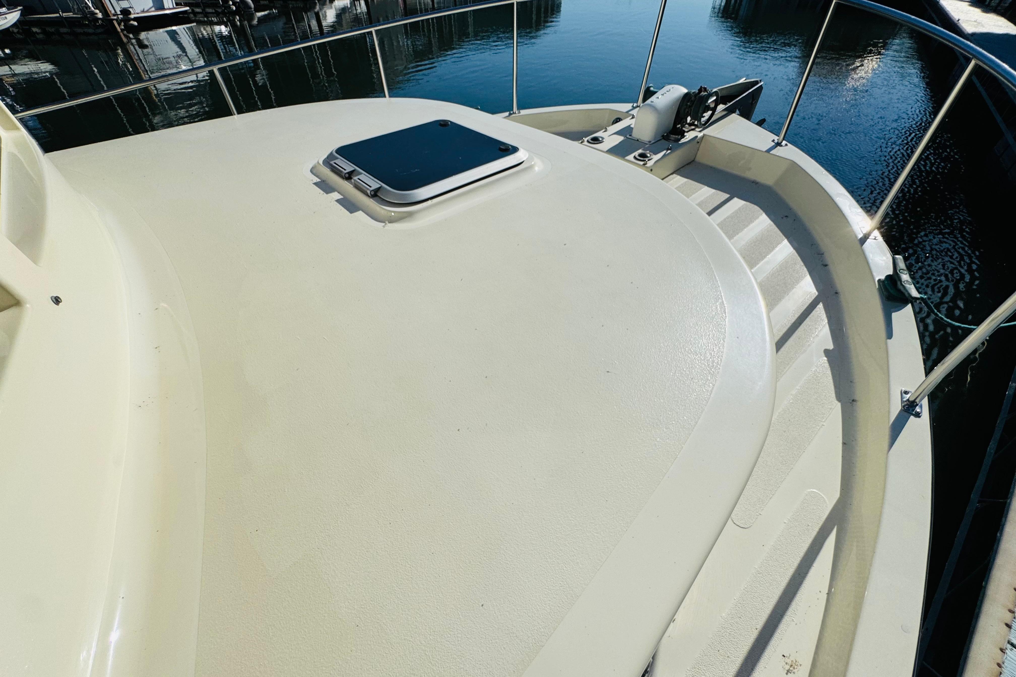 Nordic Tug 32 (1996) bow deck with hatch, docked at marina.