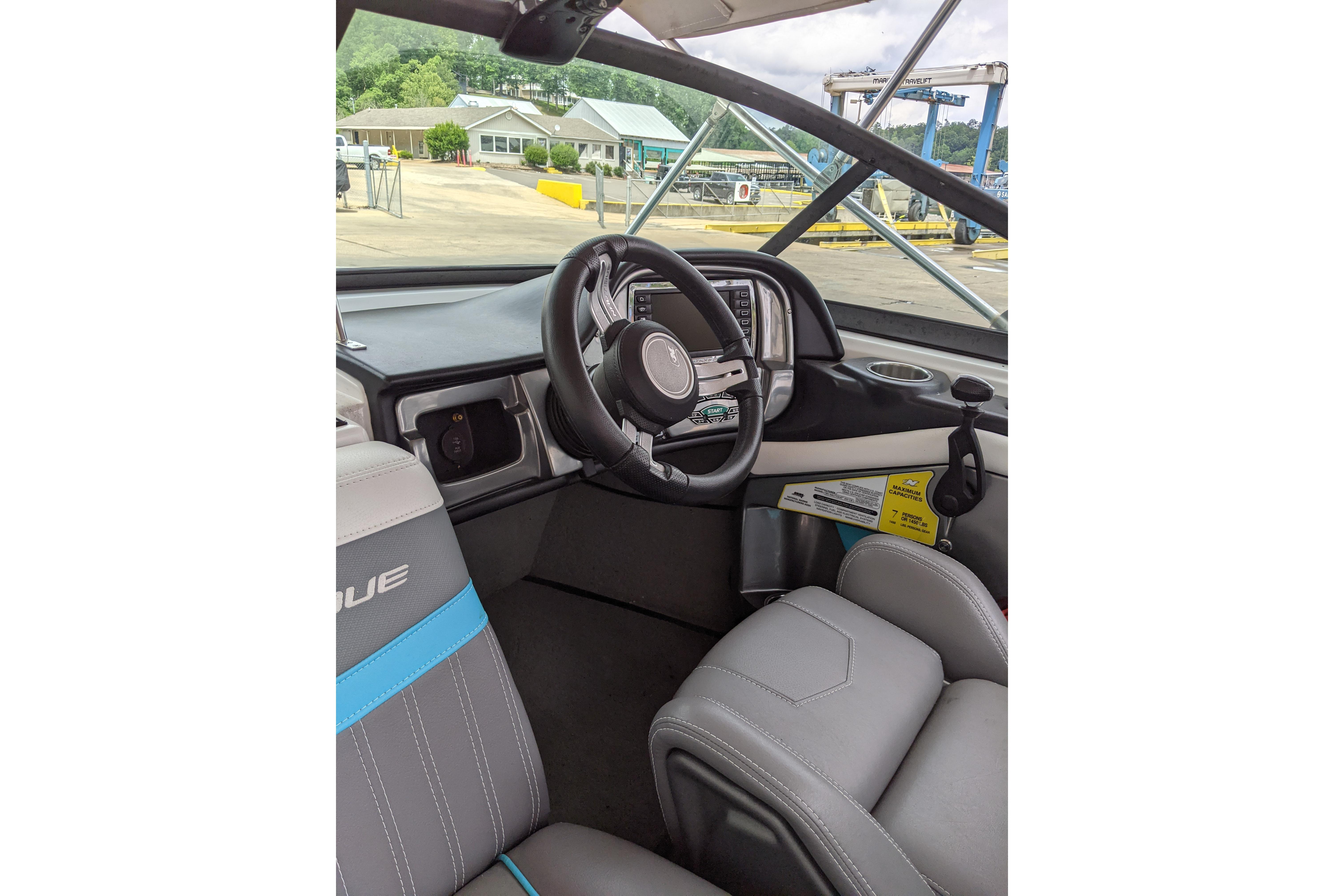 Interior of 2016 Nautique Ski Nautique 200 Closed Bow, featuring steering wheel and dashboard.