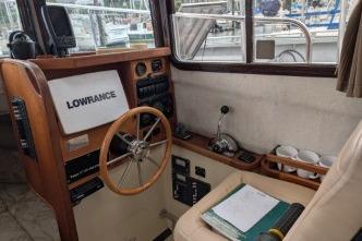 2008 Ranger 25 cockpit with steering wheel and navigation equipment.