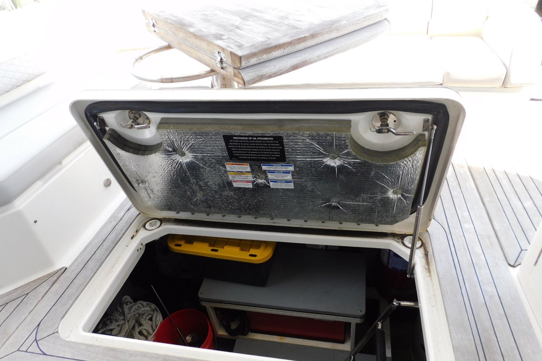 Open storage compartment on 2019 Sea Ray L550 yacht deck, showing interior contents.