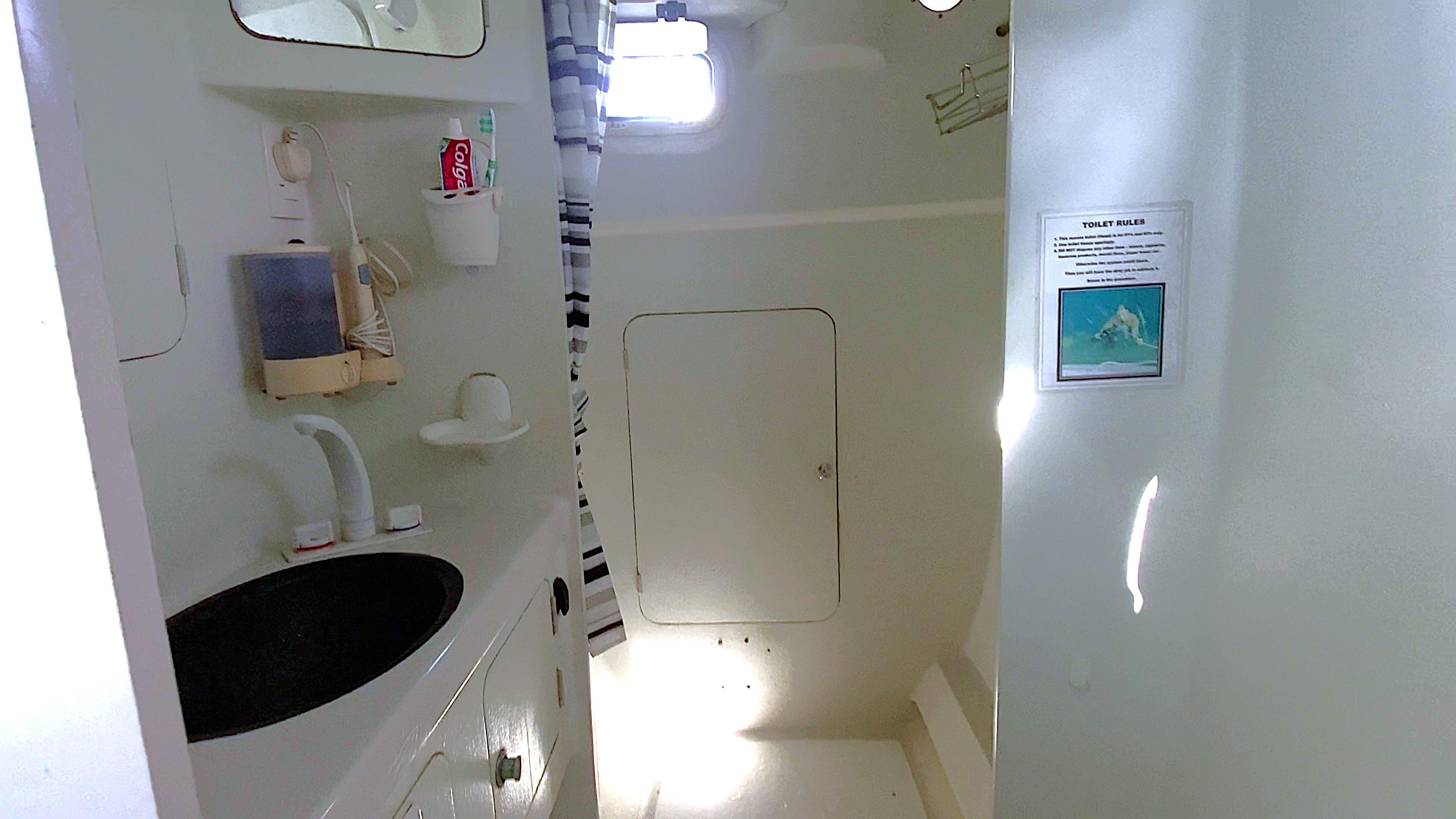 Bathroom interior of 2016 Stealth 13C boat with sink, mirror, and shower area.