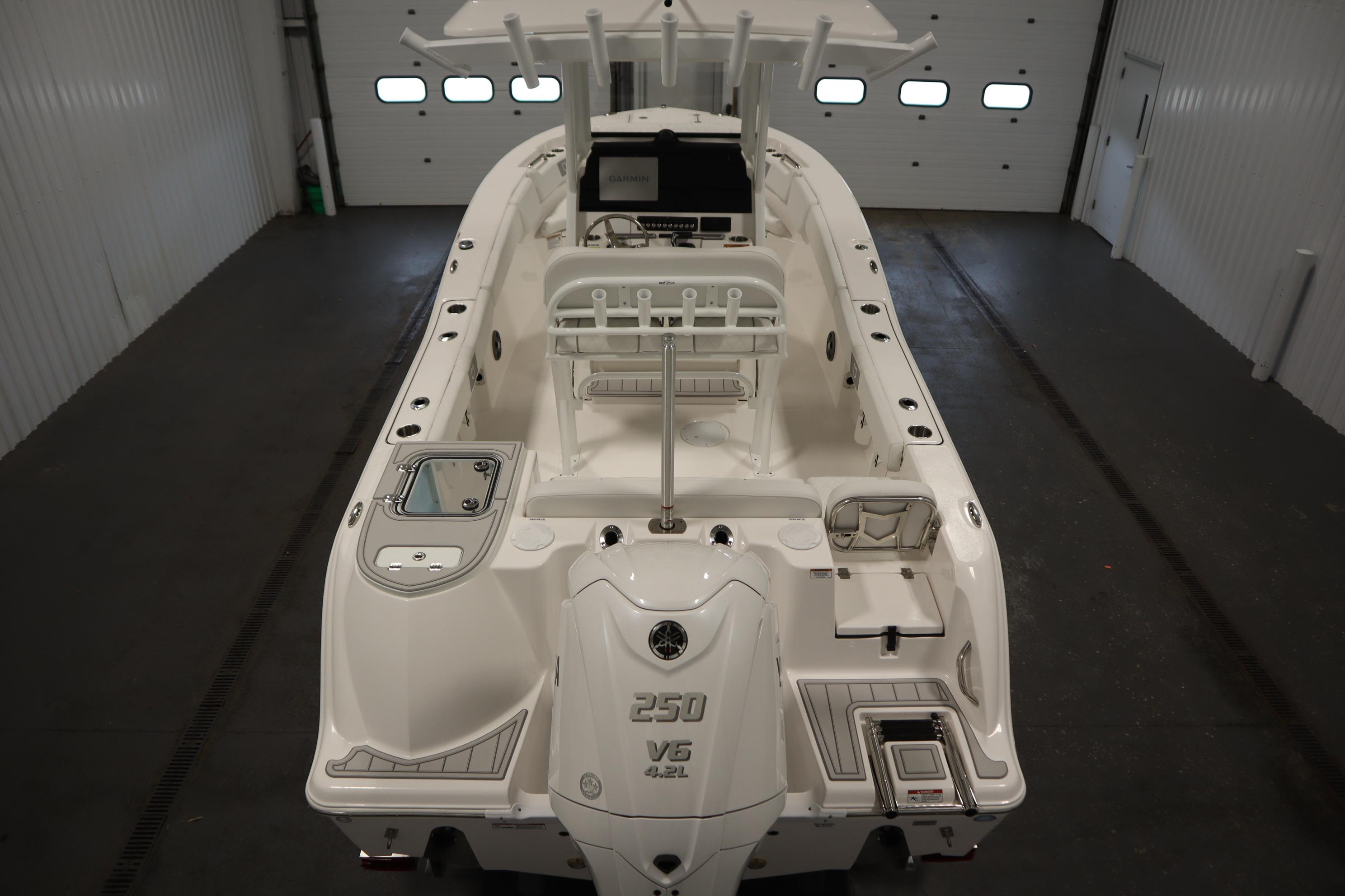 2026 Sea Fox 228 Commander boat in indoor storage, showcasing sleek design and powerful engine.