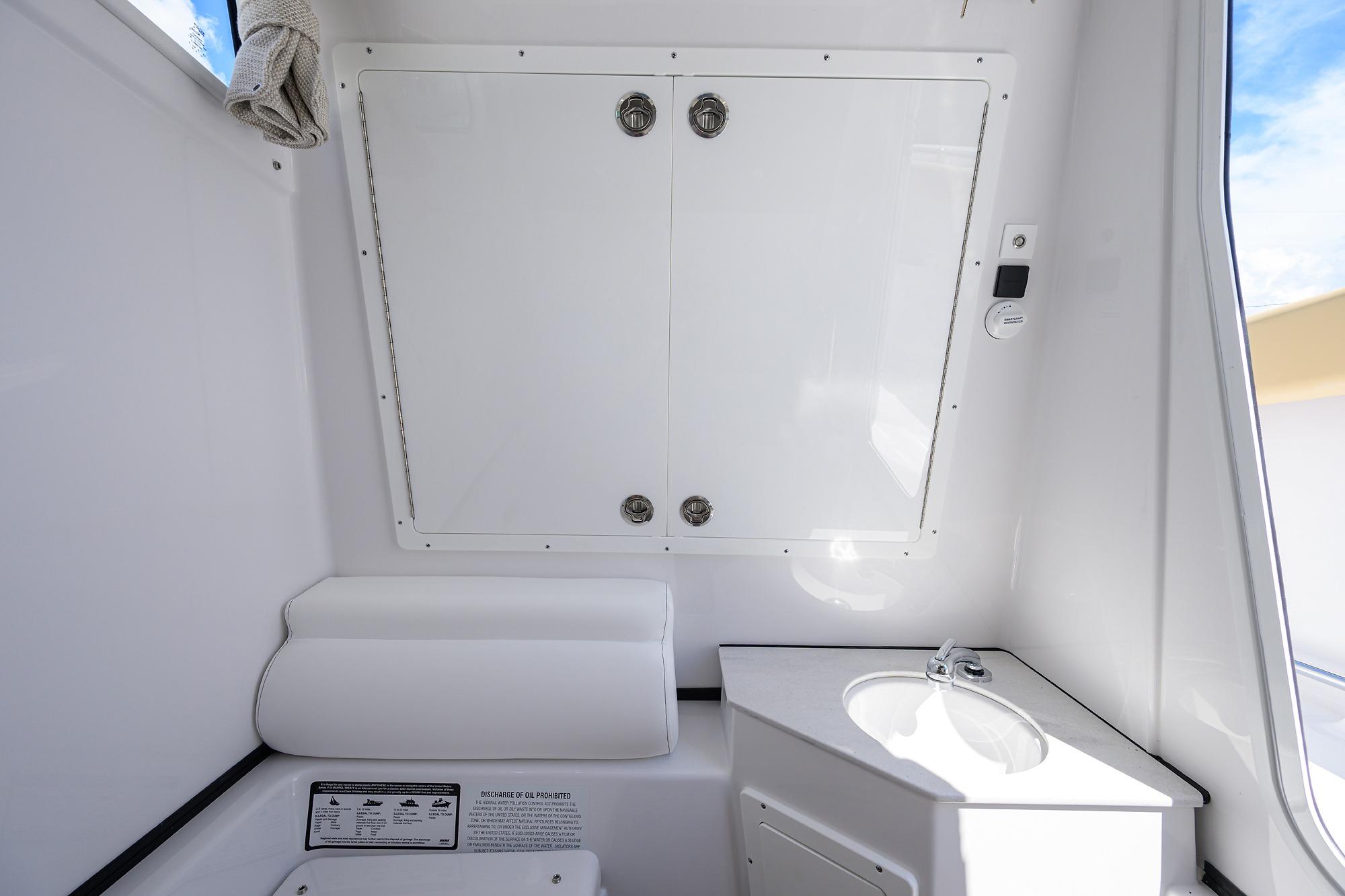 2026 Sportsman Open 302 Center Console interior with storage and sink.