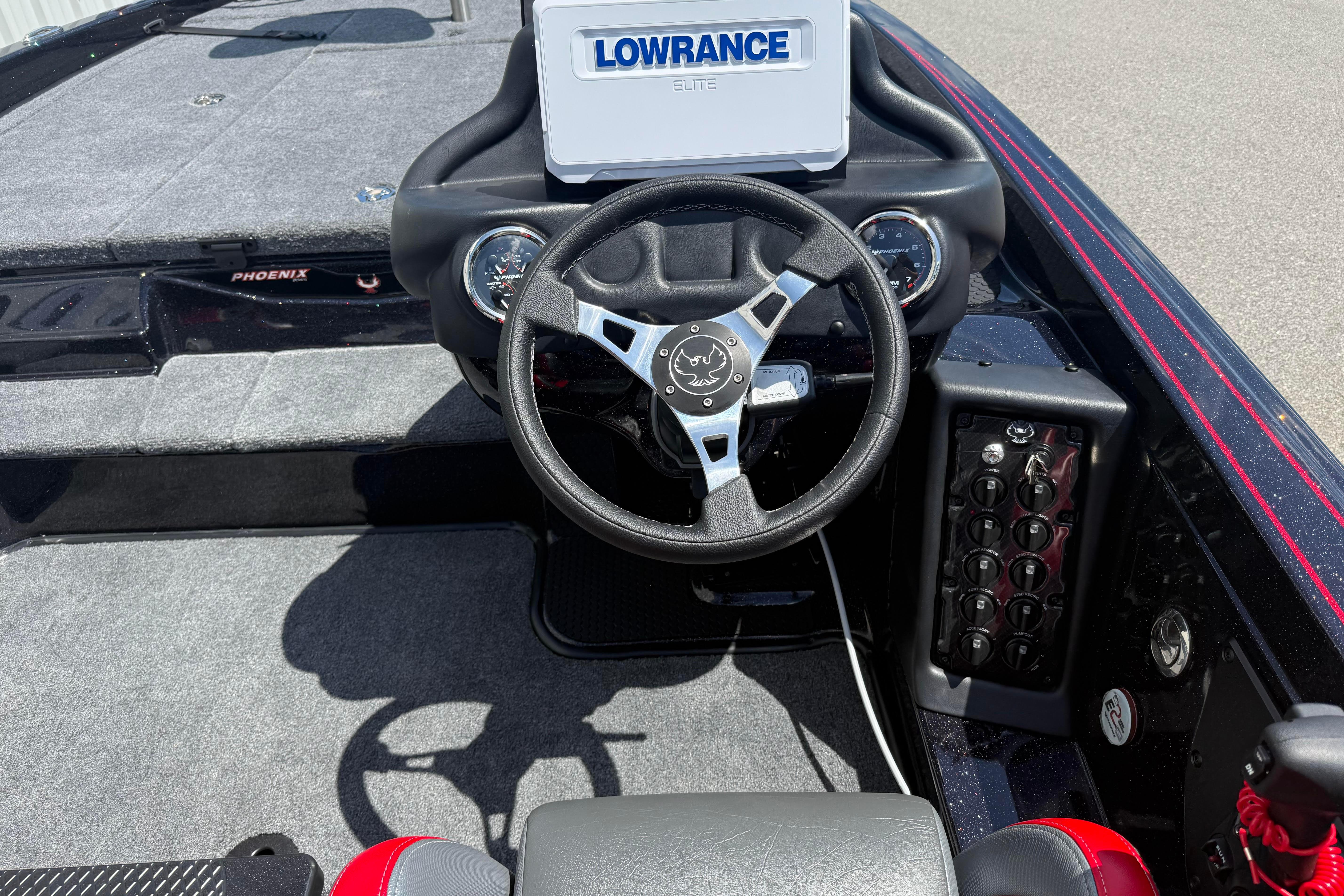 Cockpit of 2027 Phoenix 919 ZXL boat with Lowrance Elite display and steering wheel.