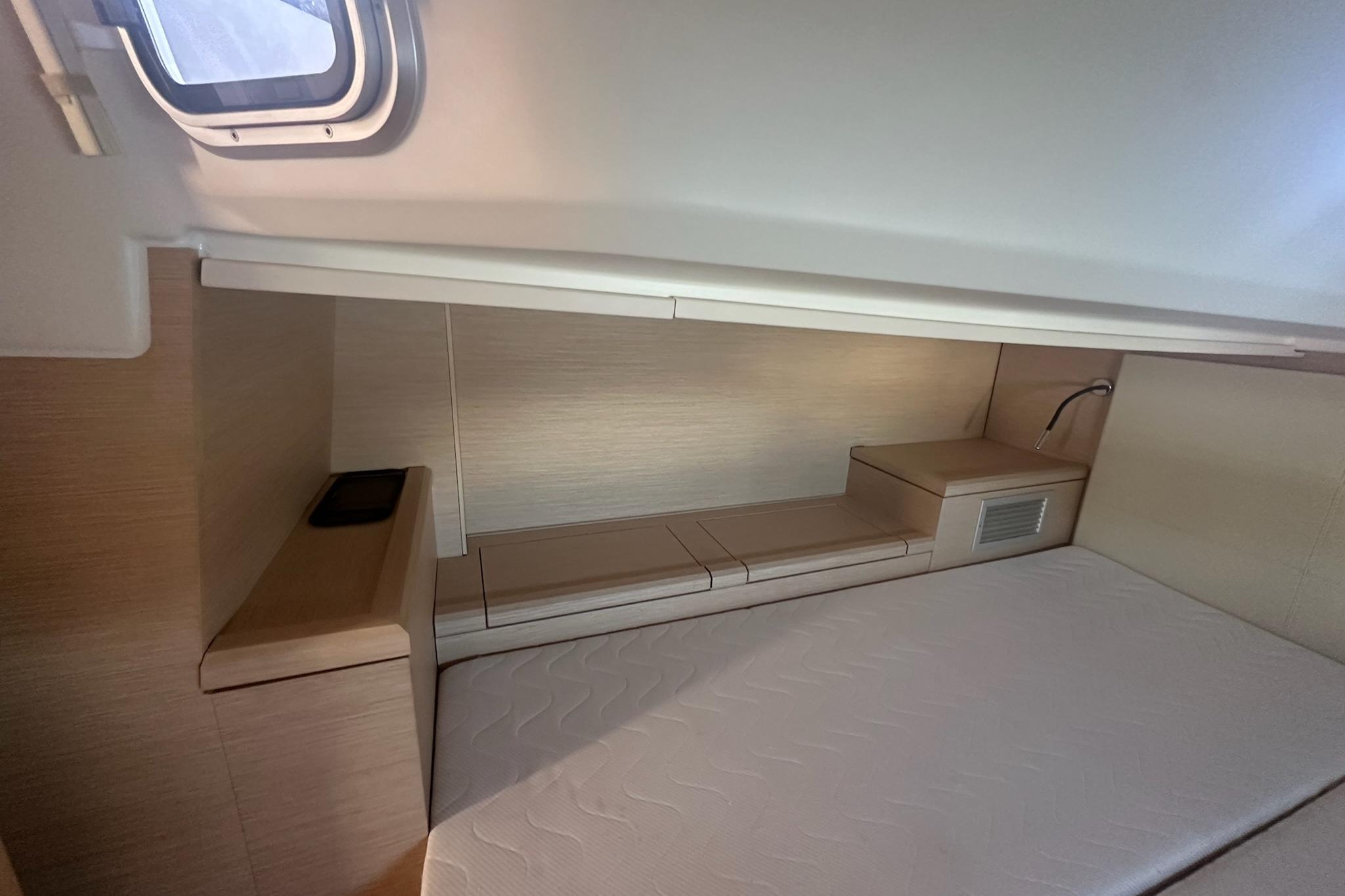 Interior cabin of 2018 Jeanneau 51 yacht, featuring a sleek, modern design with a comfortable bed.