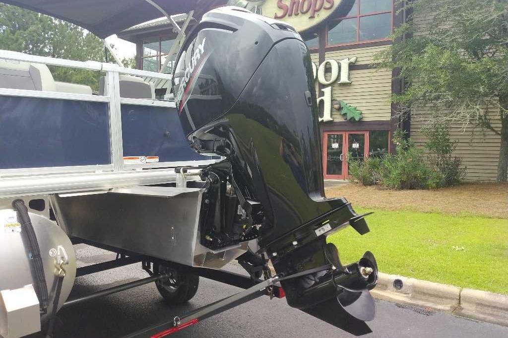 2026 Sun Tracker Bass Buggy 18 DLX with Mercury outboard motor, parked outdoors.