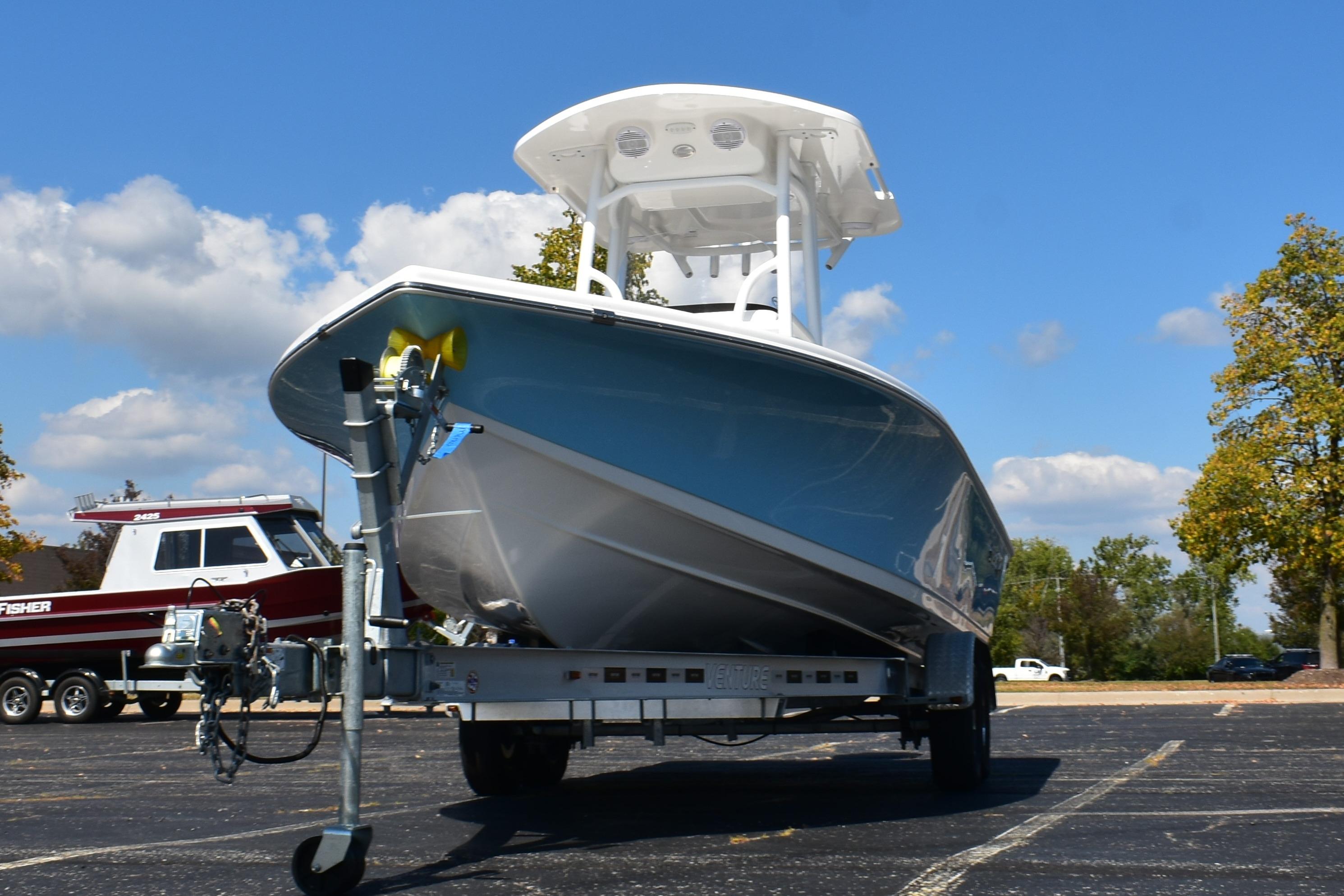 2025 Sea Pro 250 Bay boat on trailer under clear blue sky.