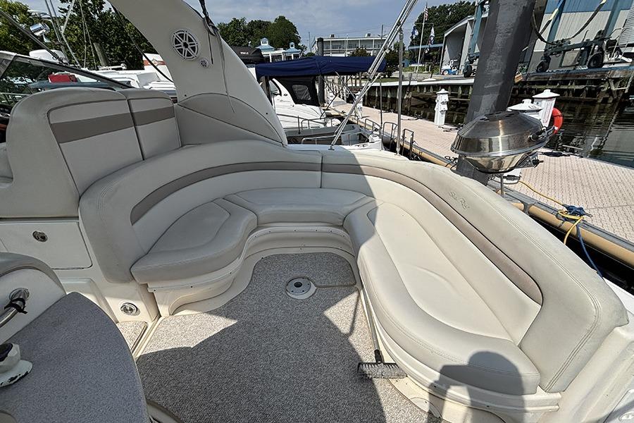 Luxurious seating area on a 2002 Sea Ray Sundancer 320 yacht, docked at a marina.