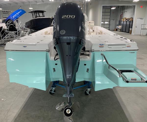 2026 Robalo 226 Cayman boat with a 200 HP engine in a showroom.