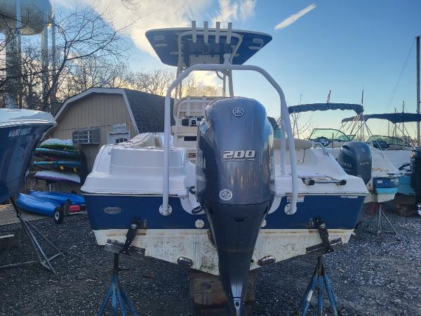 2021 NauticStar 2302 Legacy boat with Yamaha 200 outboard motor in a marina.
