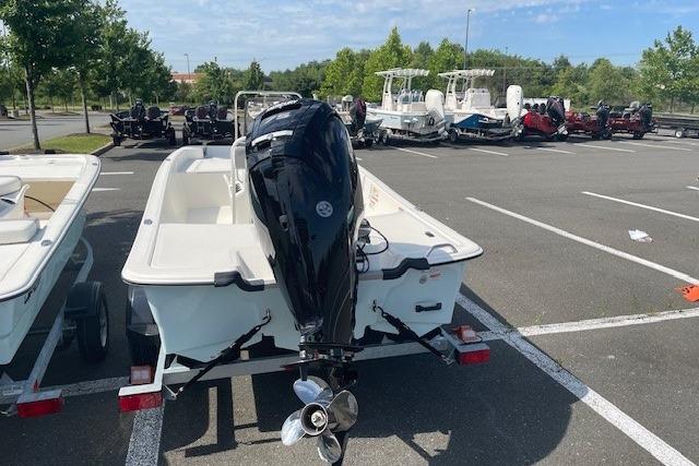 2026 Mako Pro Skiff 17 CC boat in parking lot, rear view.