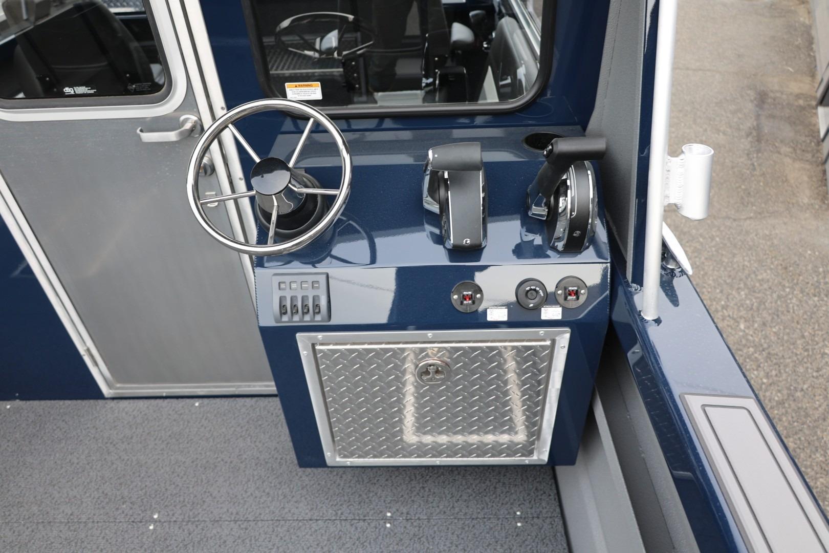 2026 Thunder Jet 24 Alexis Pro boat helm with steering wheel and control panel.