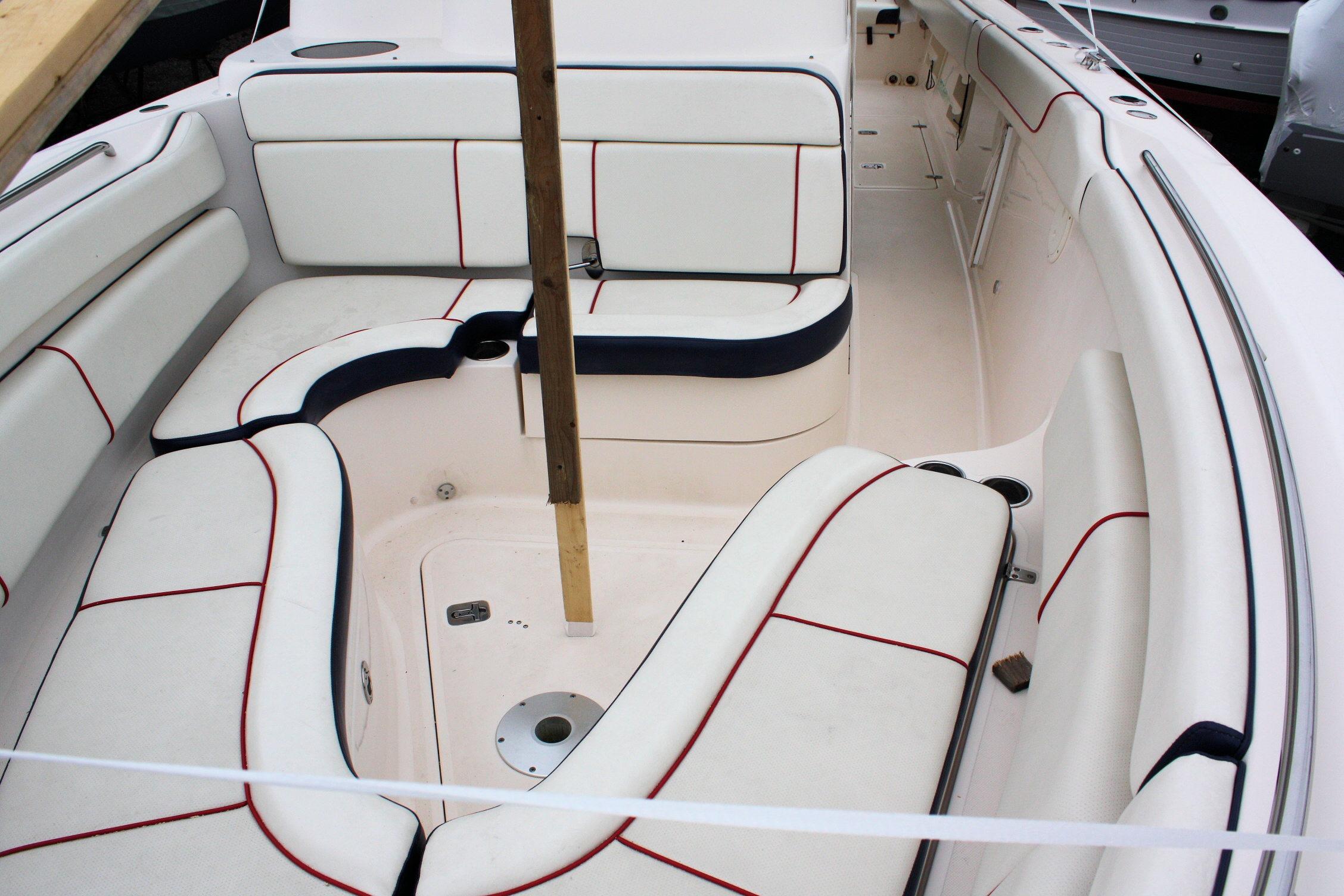 2013 Pursuit ST 310 Sport boat interior with white seating and red accents.
