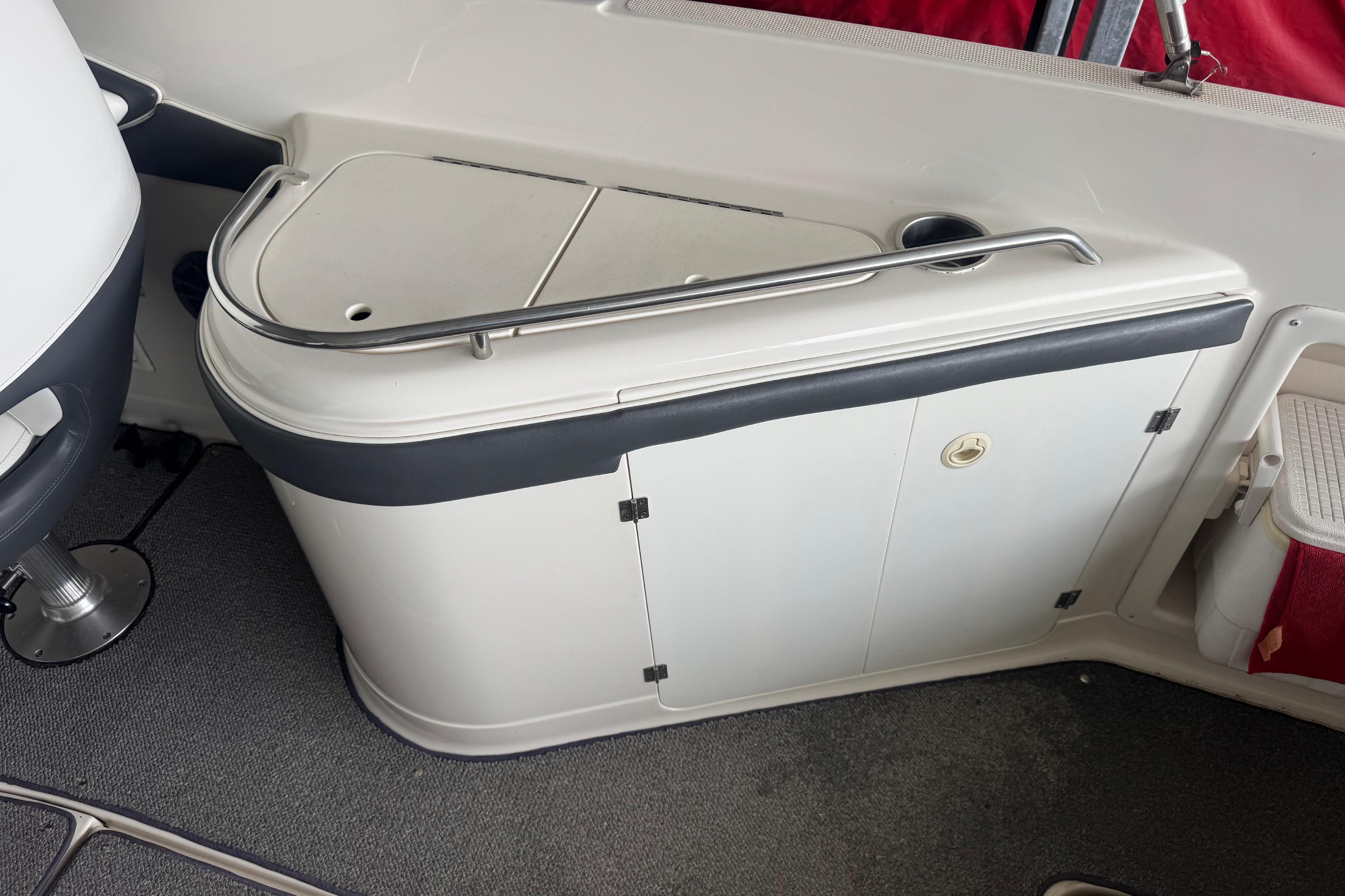 2005 Monterey 248LS Montura Bowrider interior with storage compartment and seating area.