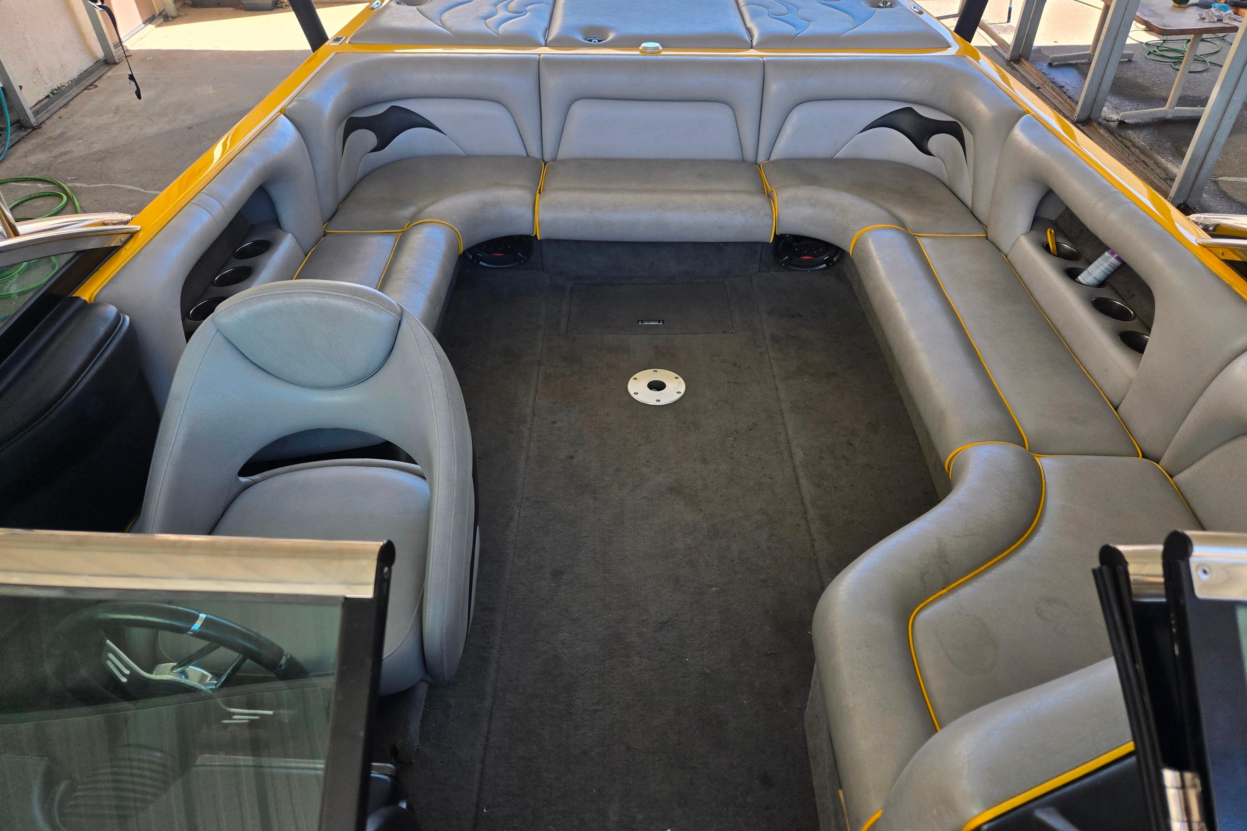 Interior of a 2007 Calabria CAL AIR PRO V boat with gray seating and yellow accents.