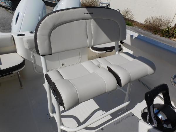 2024 Sailfish 242 CC boat with cushioned seating and dual outboard motors.