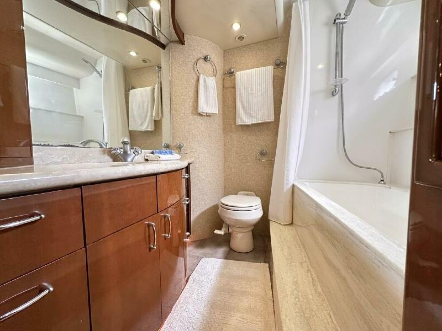 Luxurious bathroom in 2006 Marquis Flybridge Motor Yacht with wood cabinetry and modern fixtures.