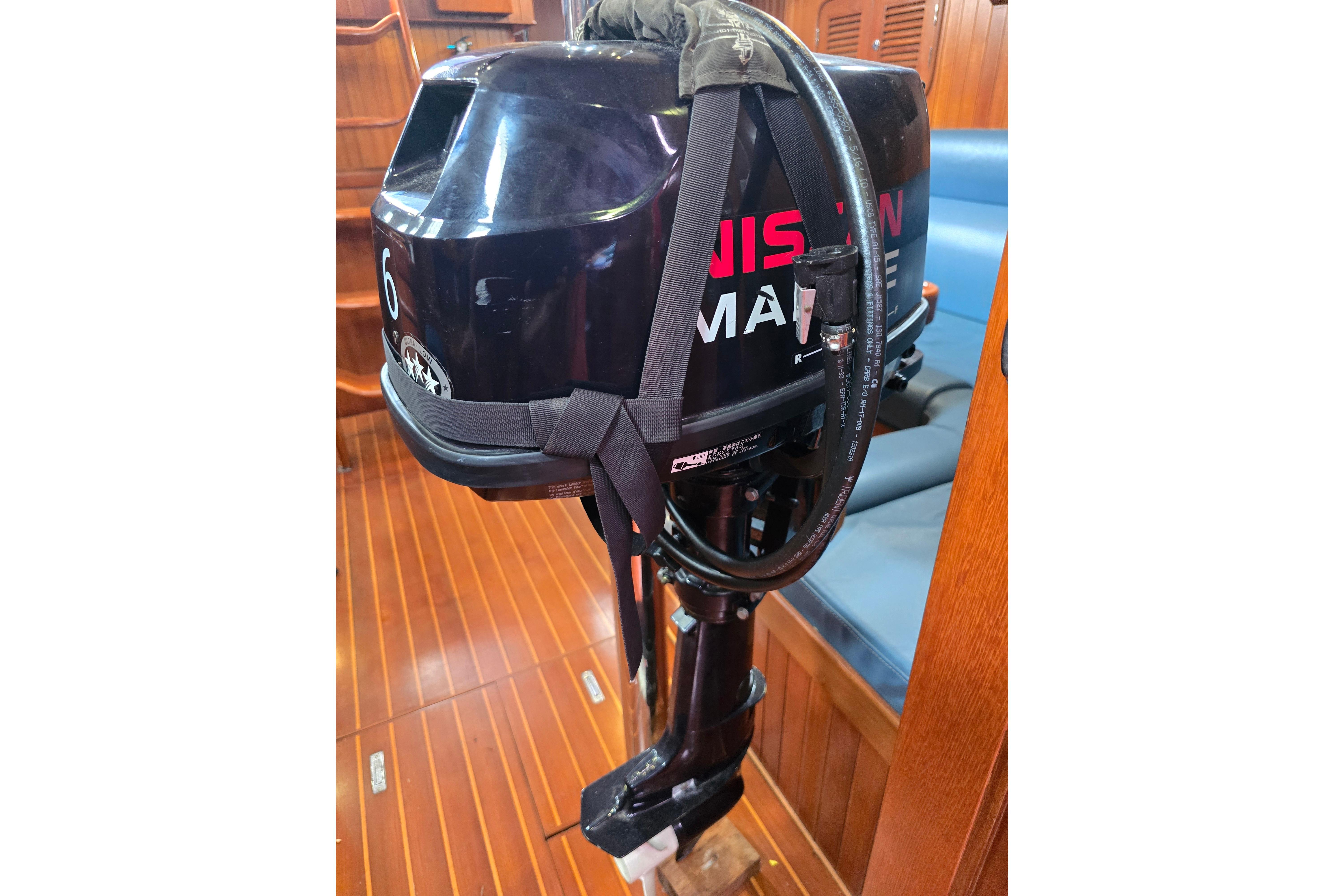 Outboard motor inside 2006 Tayana Vancouver 42 yacht with wooden flooring.