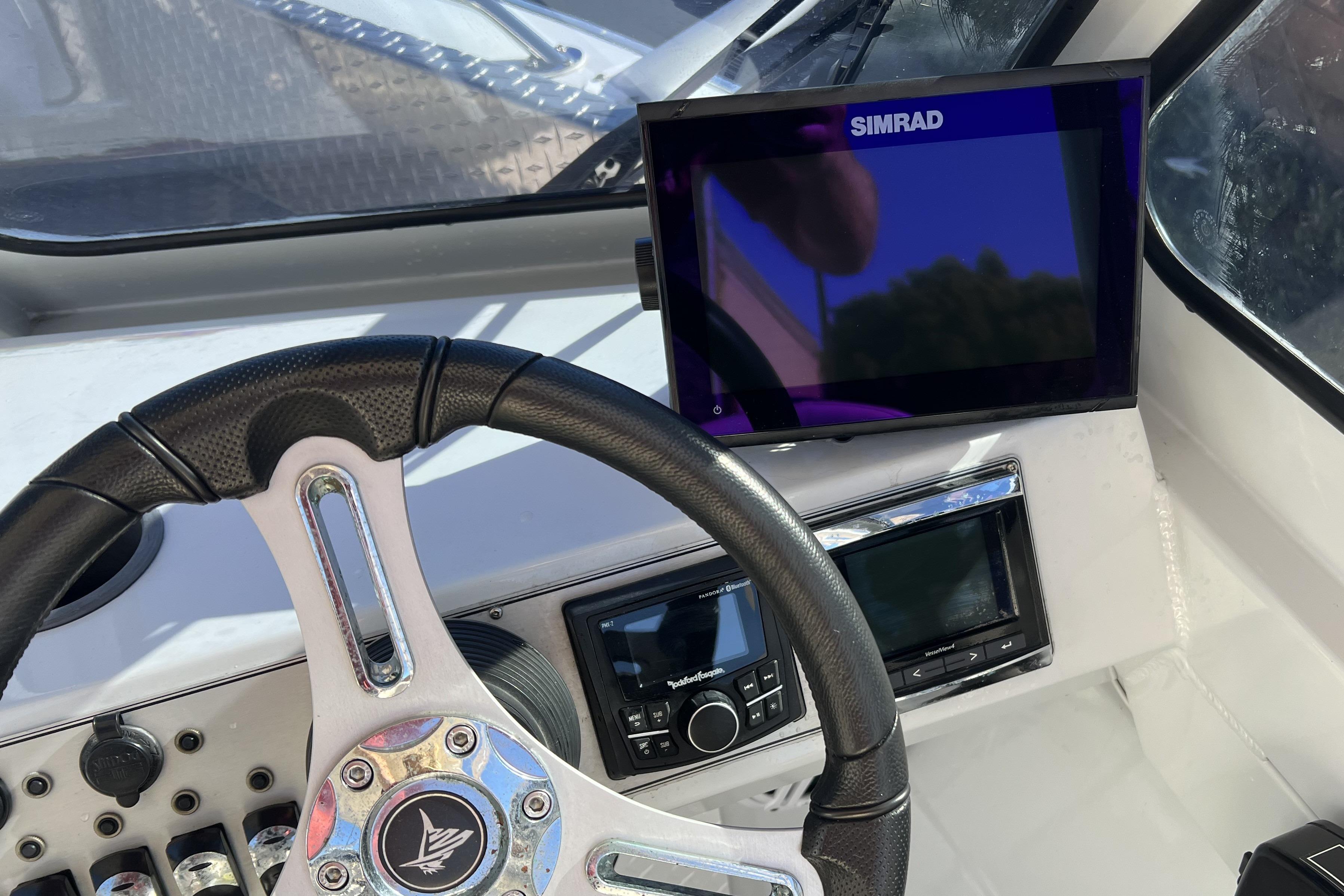 Steering wheel and dashboard of 2019 KingFisher 1825 Falcon boat with Simrad display.