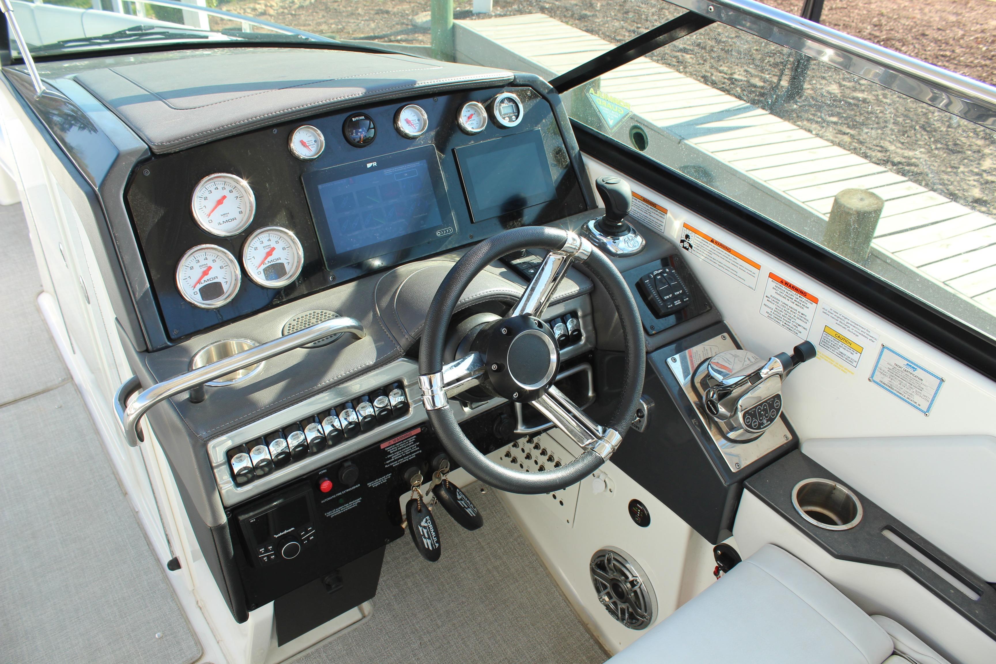 2023 Formula 310 Bowrider I/O dashboard with steering wheel and control panel.
