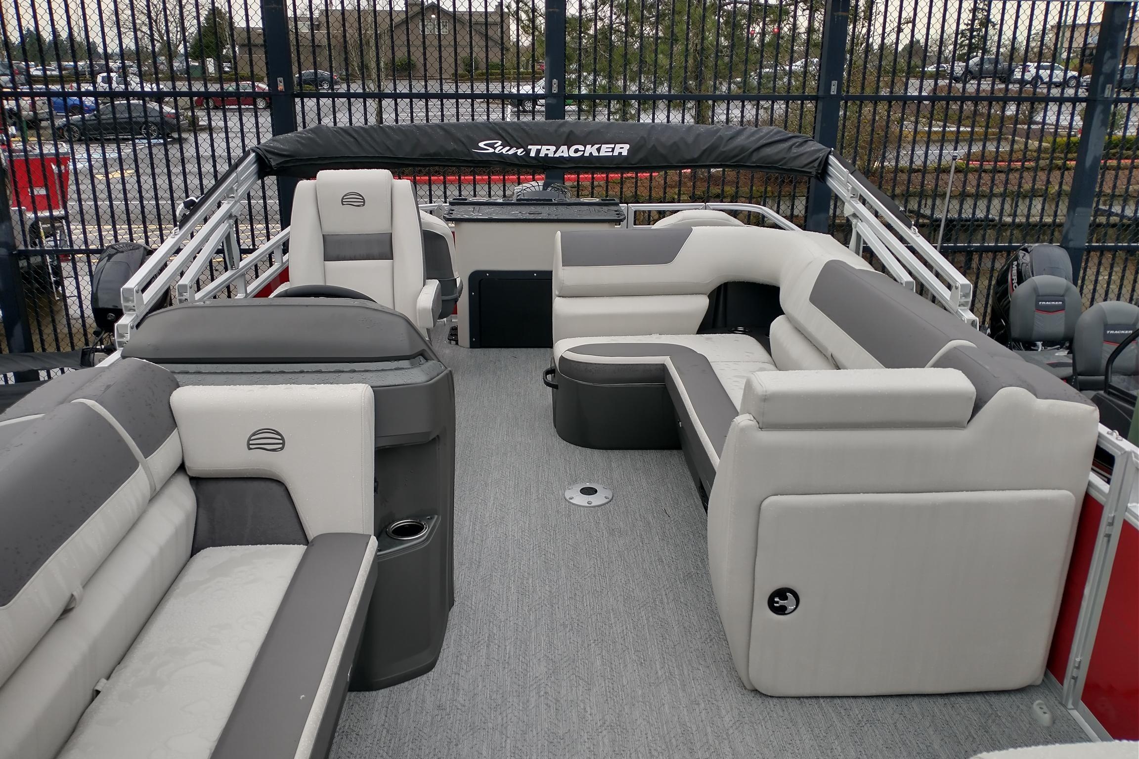 2026 Sun Tracker Fishin' Barge 22 DLX pontoon boat with spacious seating and modern design.