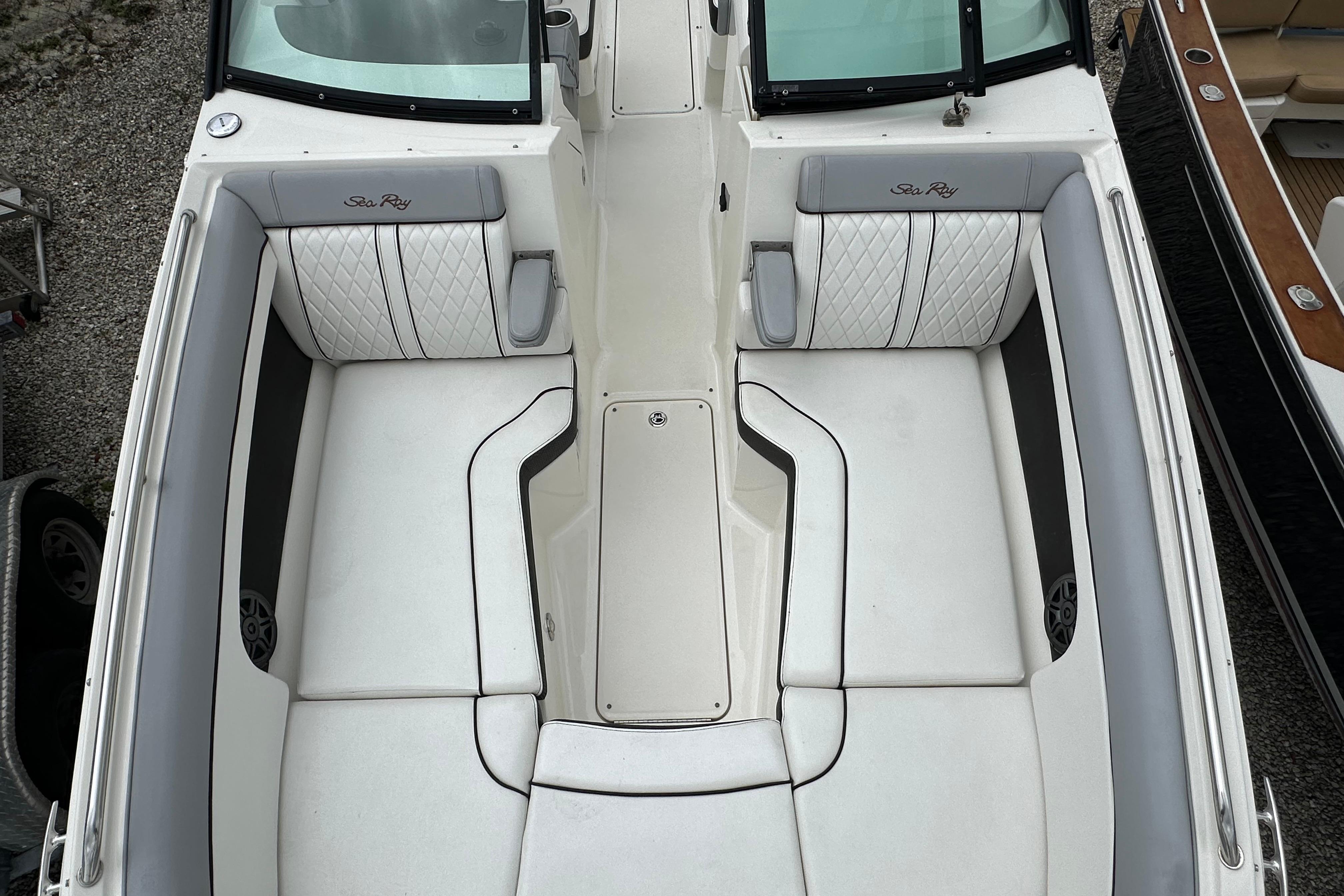 2016 Sea Ray 270 Sundeck boat interior with white cushioned seating and sleek design.