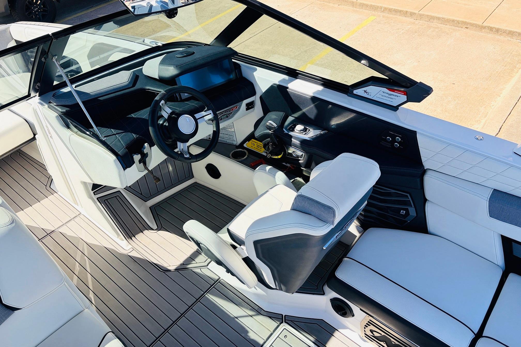 2023 Nautique Super Air Nautique G25 boat interior with modern steering and seating.
