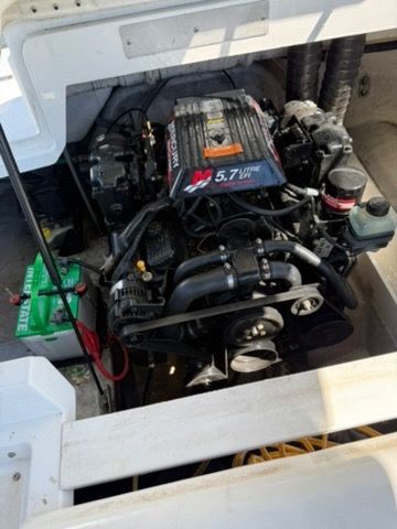 An engine compartment with a 5.7-liter engine and a battery.