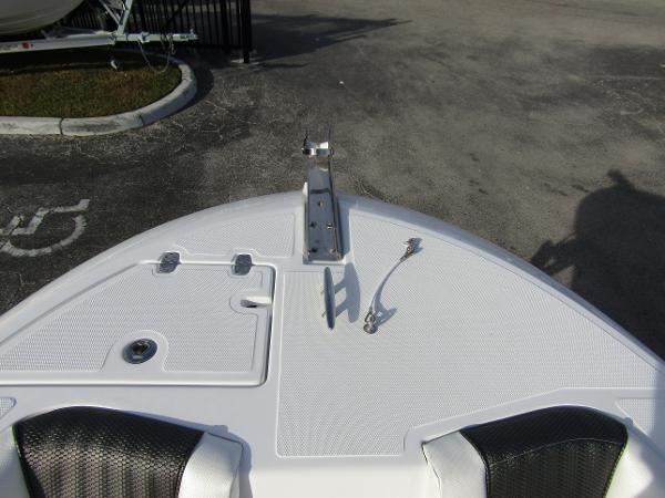 Bow of 2025 Wellcraft 243 Fisherman boat with anchor mount and storage hatches.