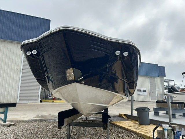 A Monterey M-45 boat is on a stand in a shipyard area.