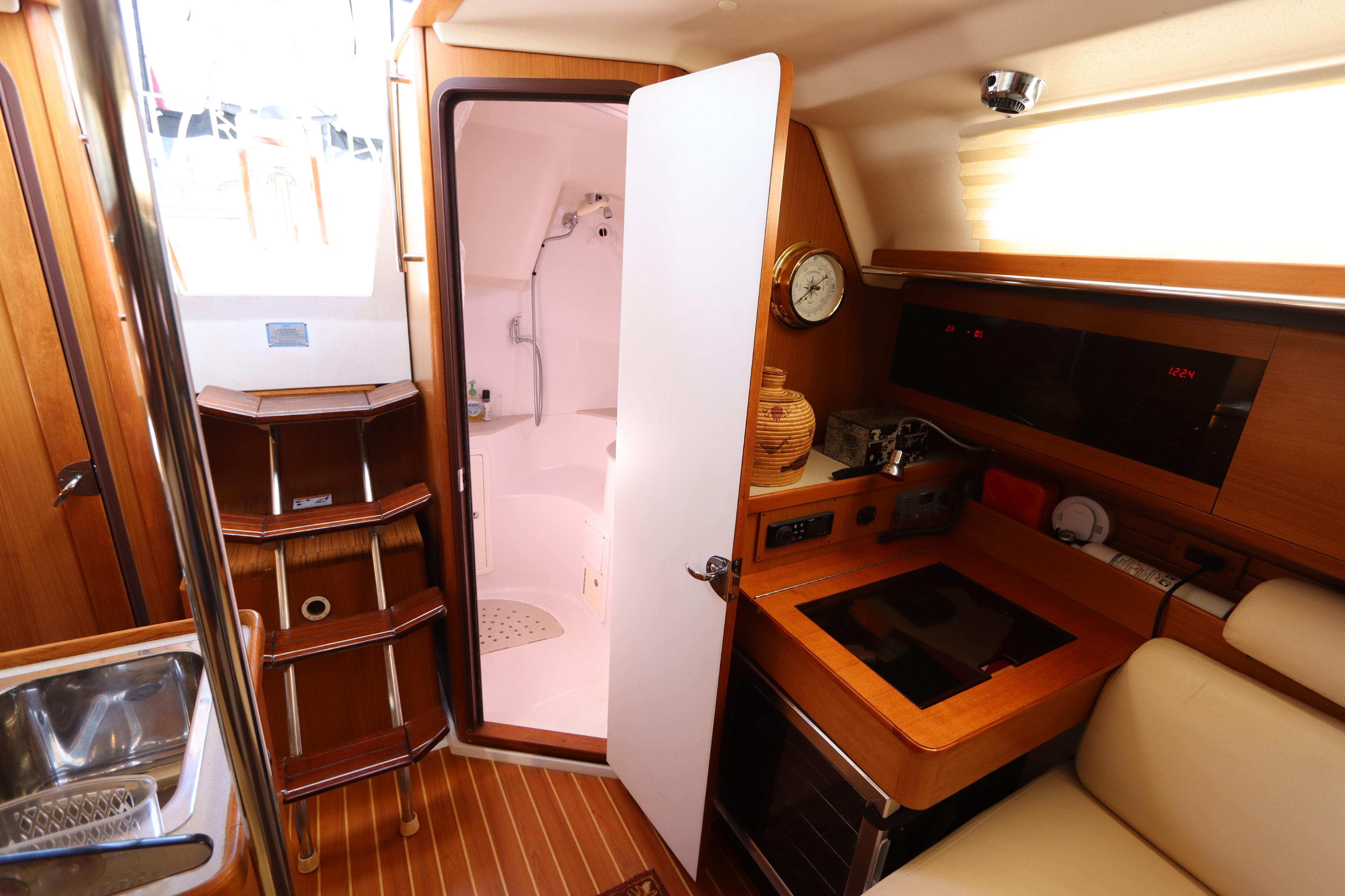 Interior of 2011 Catalina 355 sailboat with compact kitchen and bathroom.