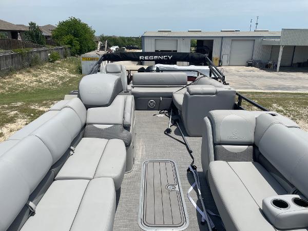 2023 Regency 250 DL3 pontoon boat with spacious seating and modern design.