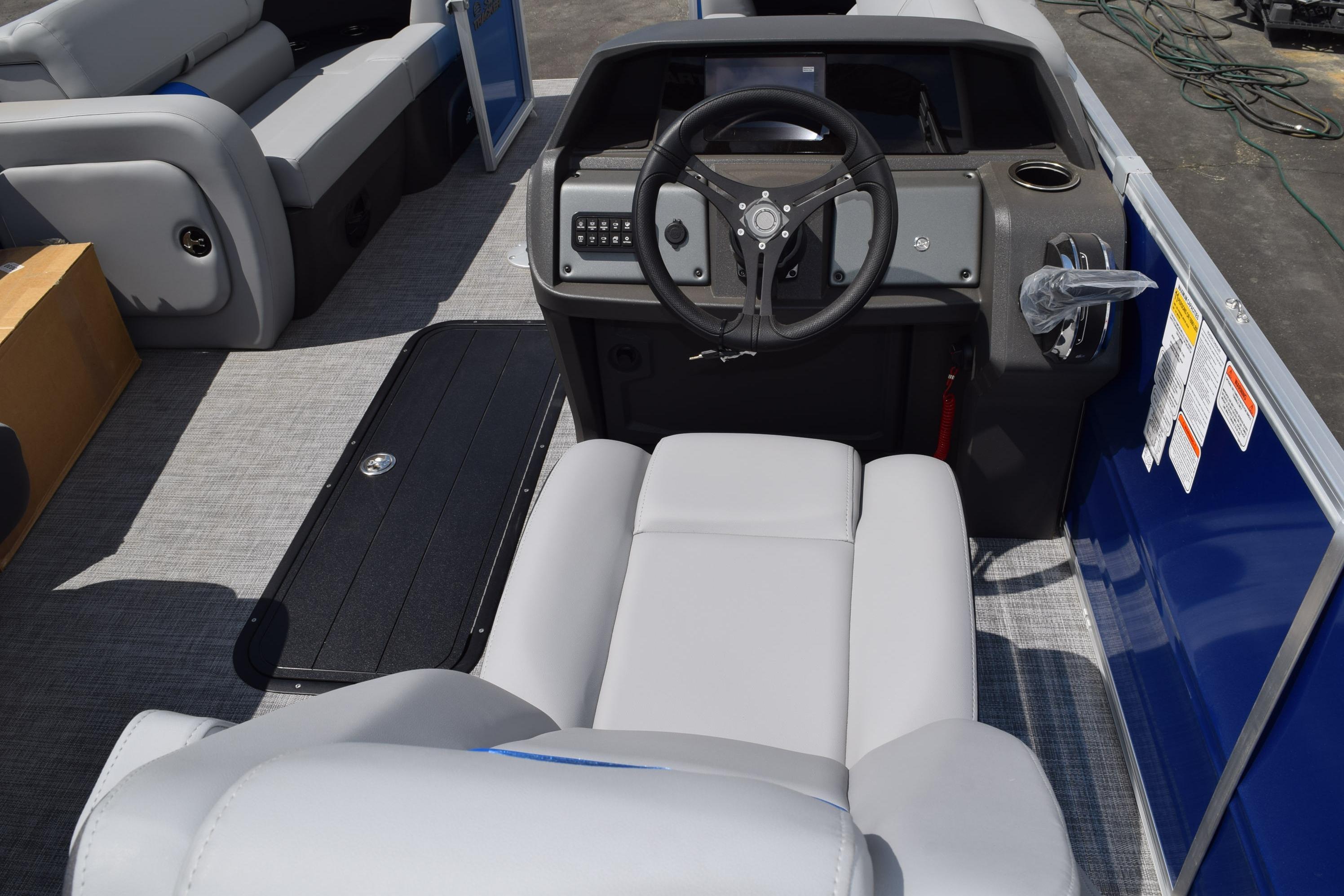 Interior view of 2026 Sun Tracker Party Barge 22 RF XP3, featuring steering console and seating.