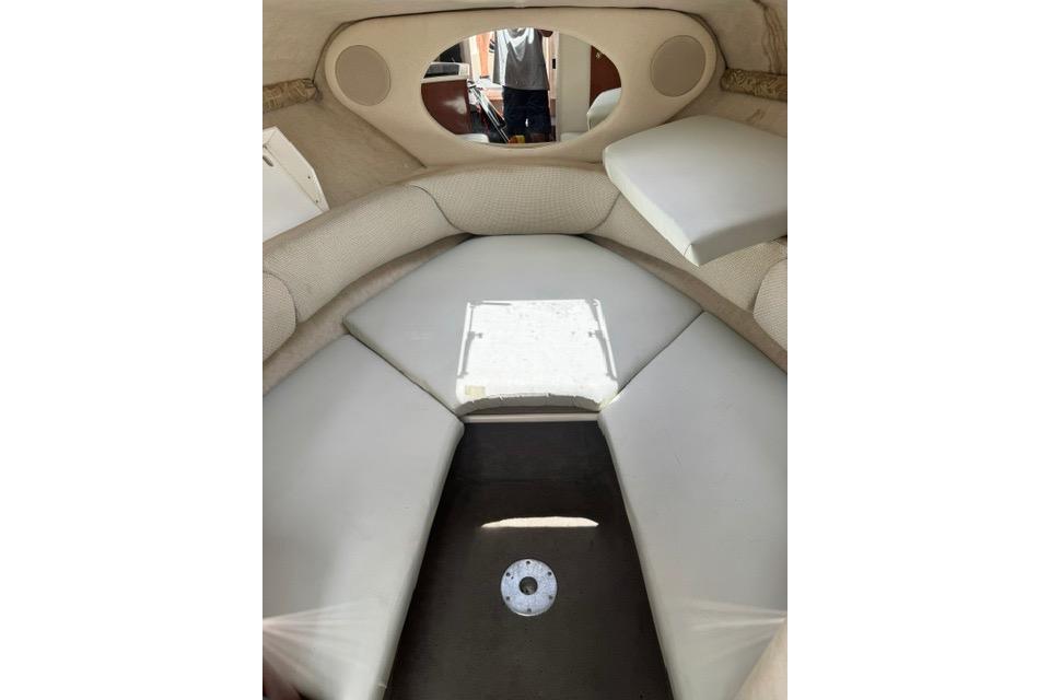 Interior cabin of 2004 Sea Ray 240 Sundancer boat with cushioned seating.