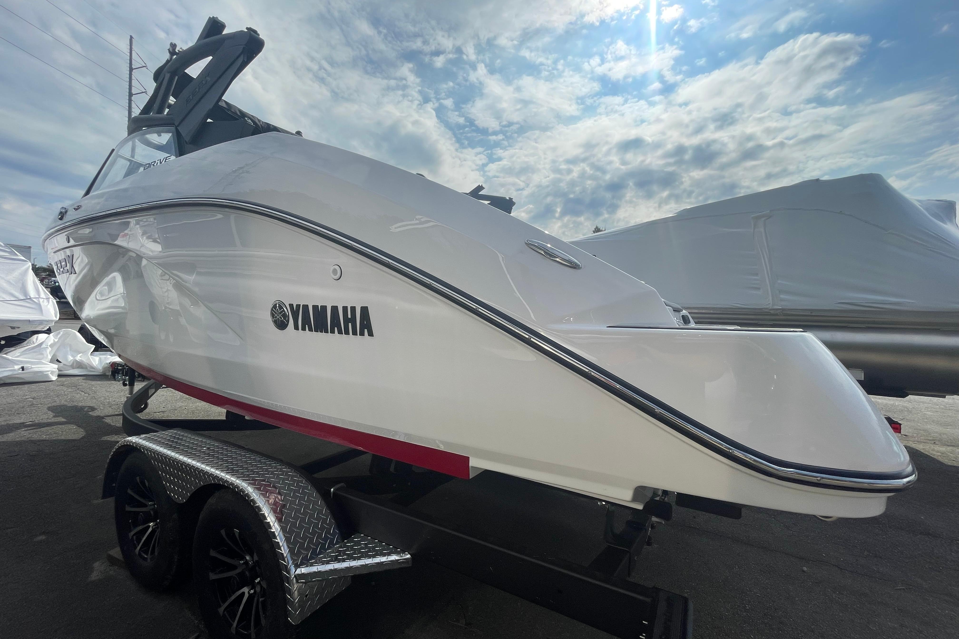 2026 Yamaha Boats 222XD on trailer under a partly cloudy sky.