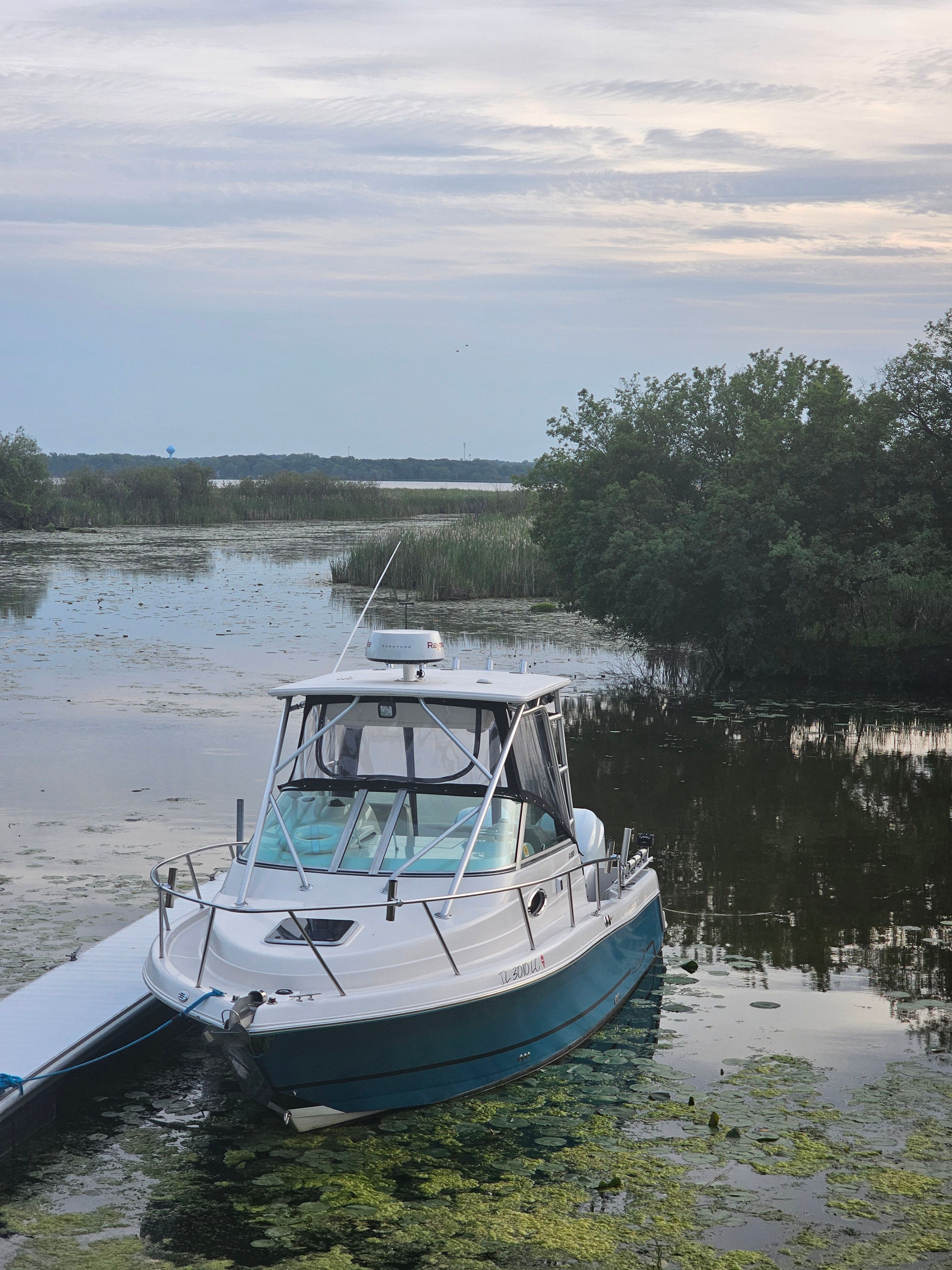 2005 Robalo R265 Walkaround boat on a tranquil lake.