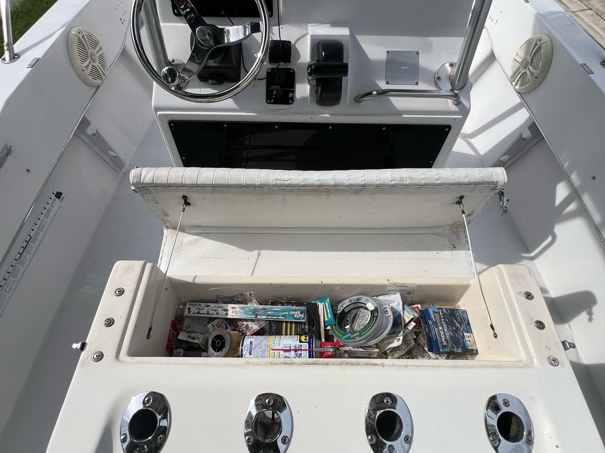 The image shows the cockpit of a 1994 Sea Ray Laguna boat with an open storage compartment.